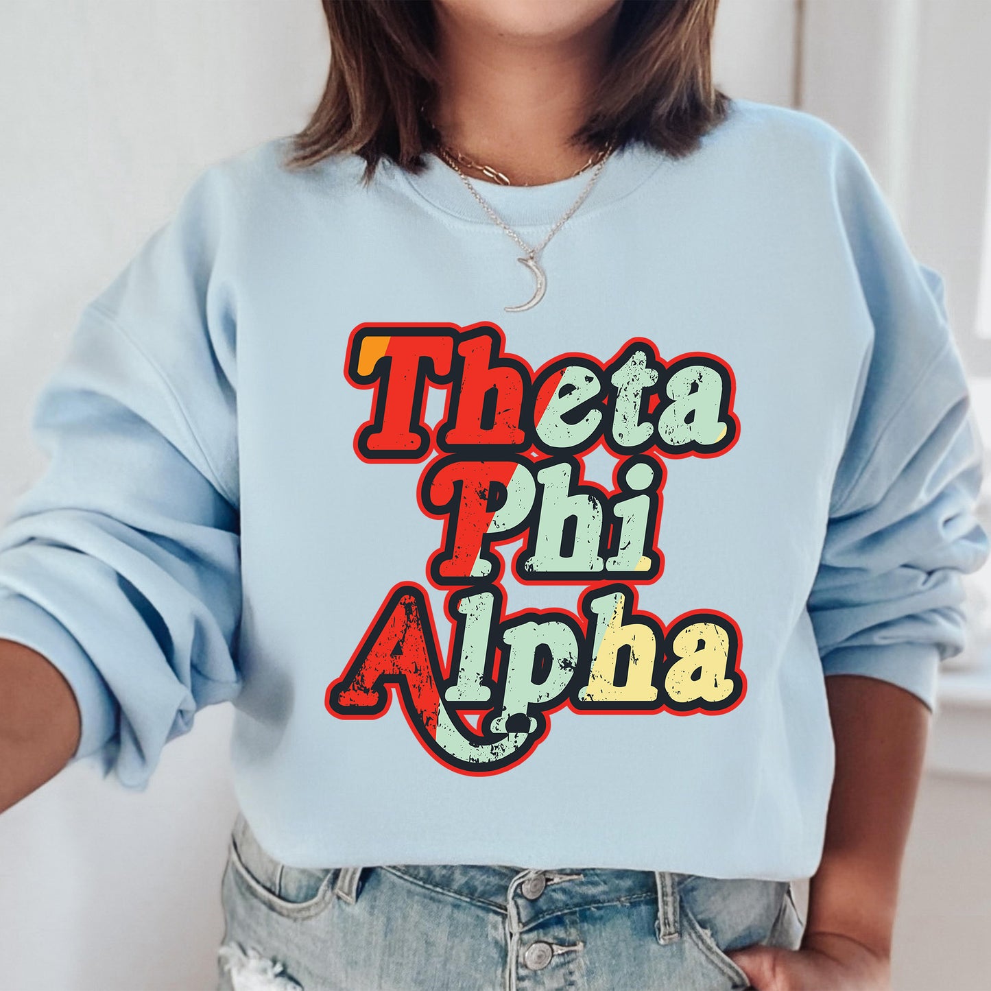 a woman wearing a blue sweatshirt with the words'thaa phi alpha '