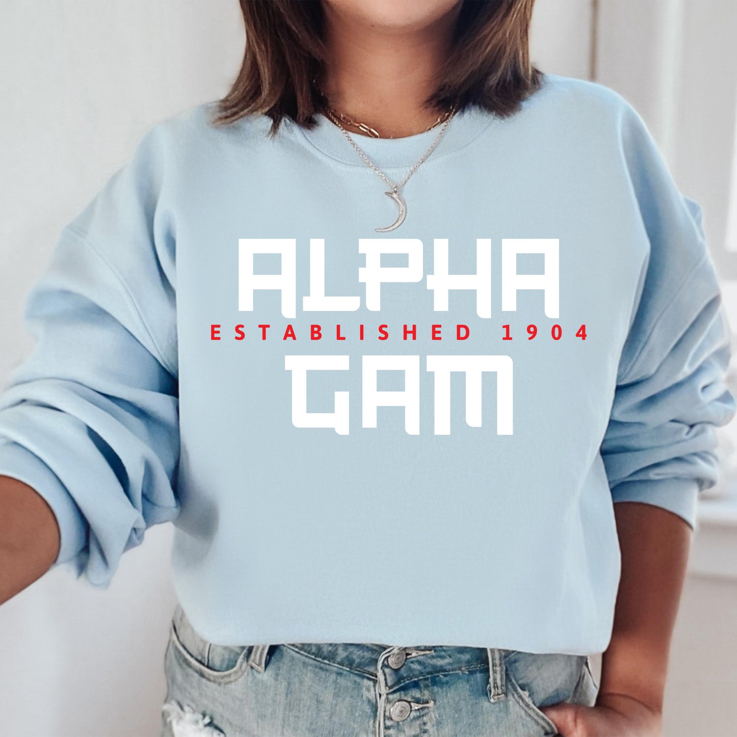 a woman wearing a blue sweatshirt with the words alphabet gam printed on it