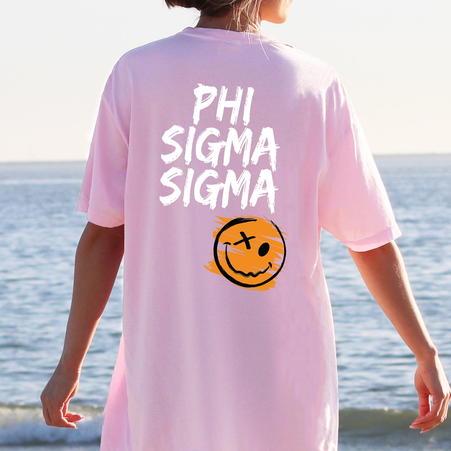 a person wearing a pink shirt with a smiley face on it