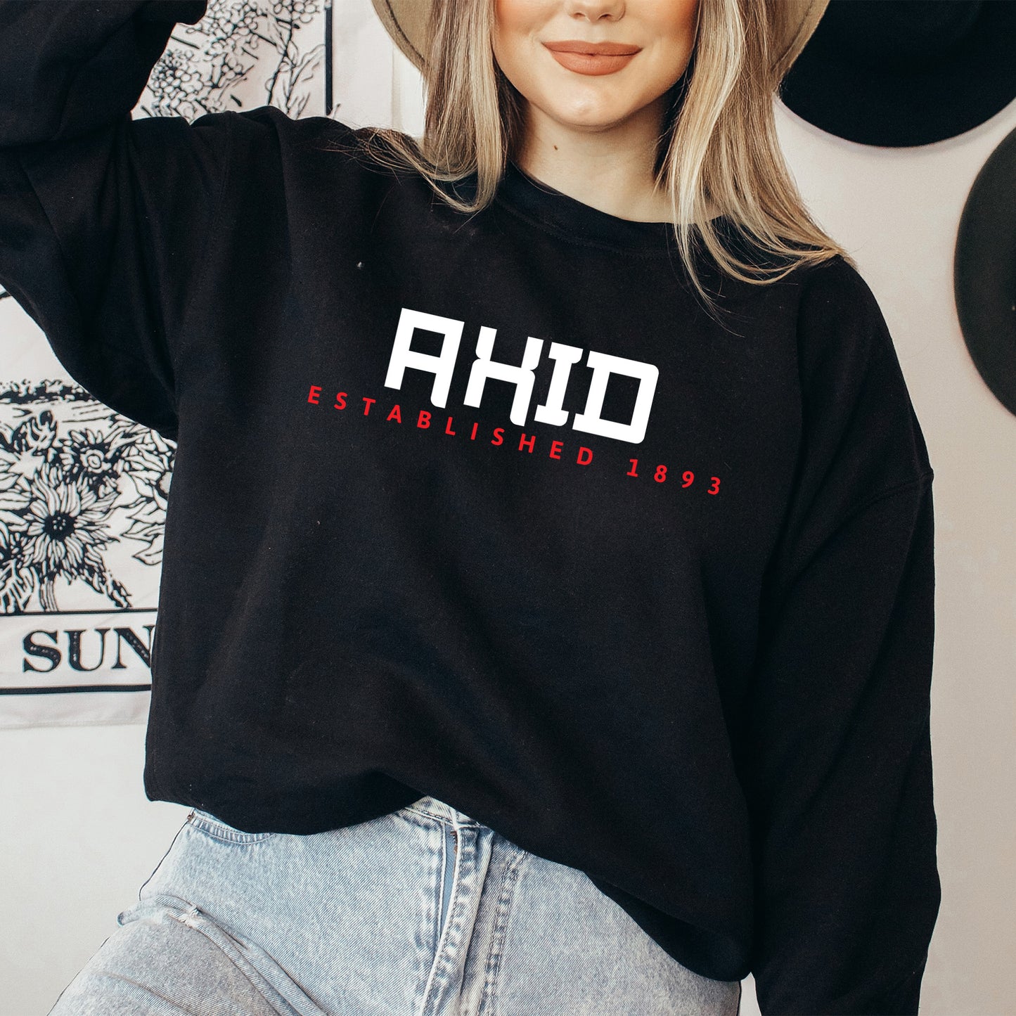 a woman wearing a hat and a sweatshirt