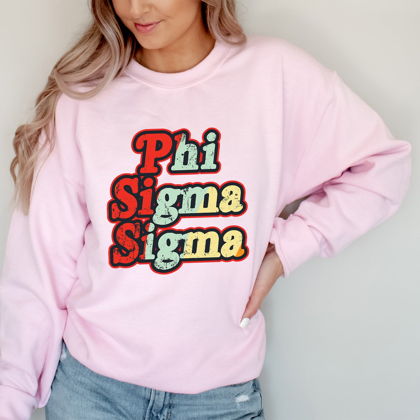 a woman wearing a pink sweatshirt that says phi sigmama