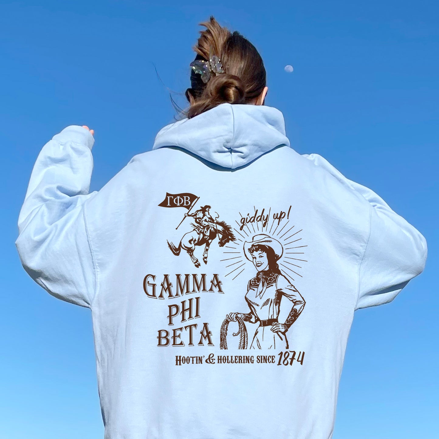 a woman wearing a white hoodie with a picture of a woman on it