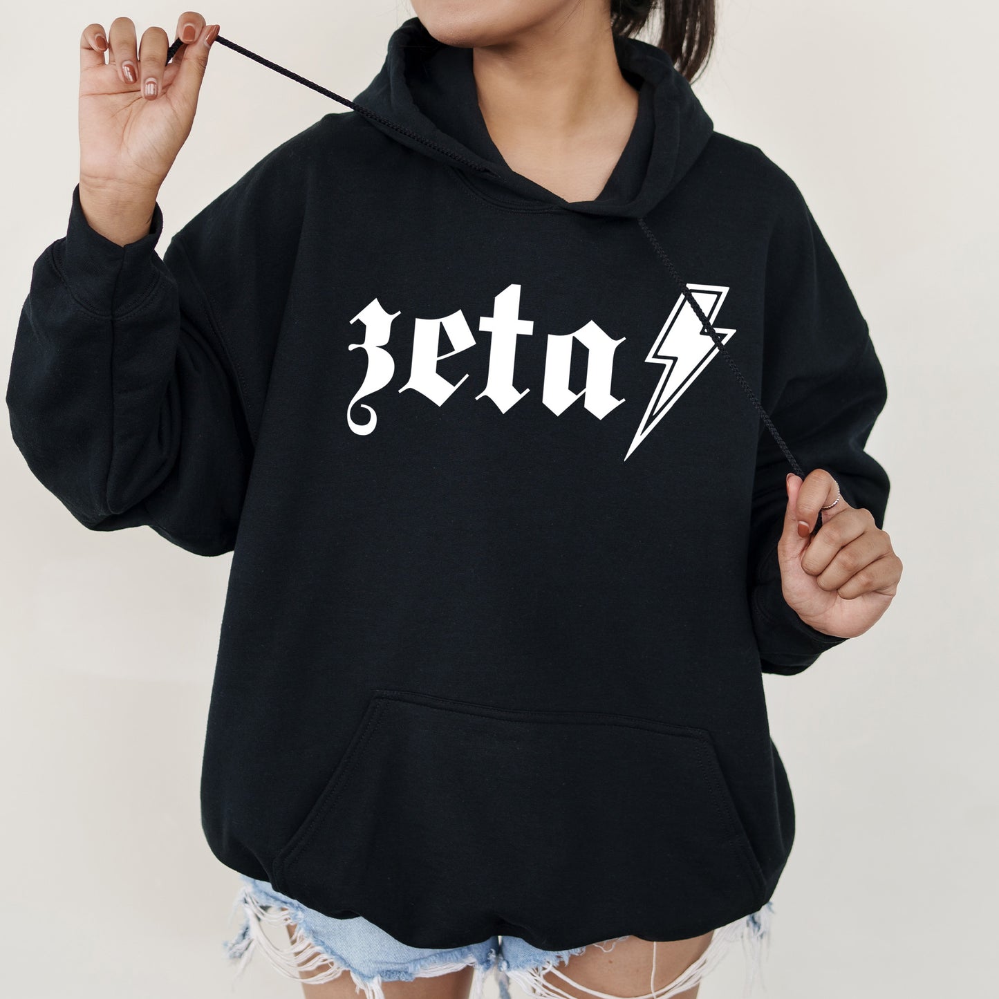 a woman wearing a black hoodie with a lightning bolt on it