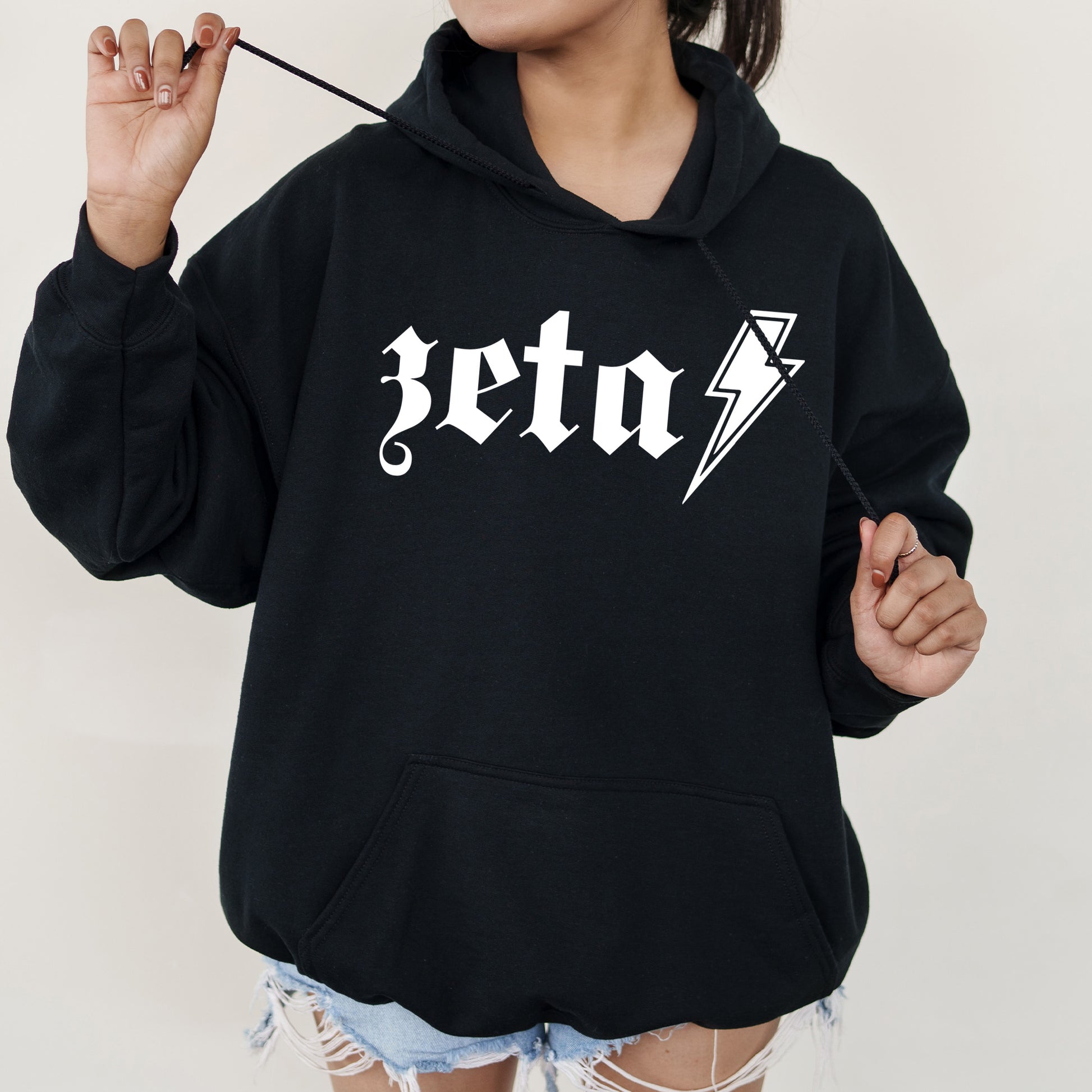 a woman wearing a black hoodie with a lightning bolt on it