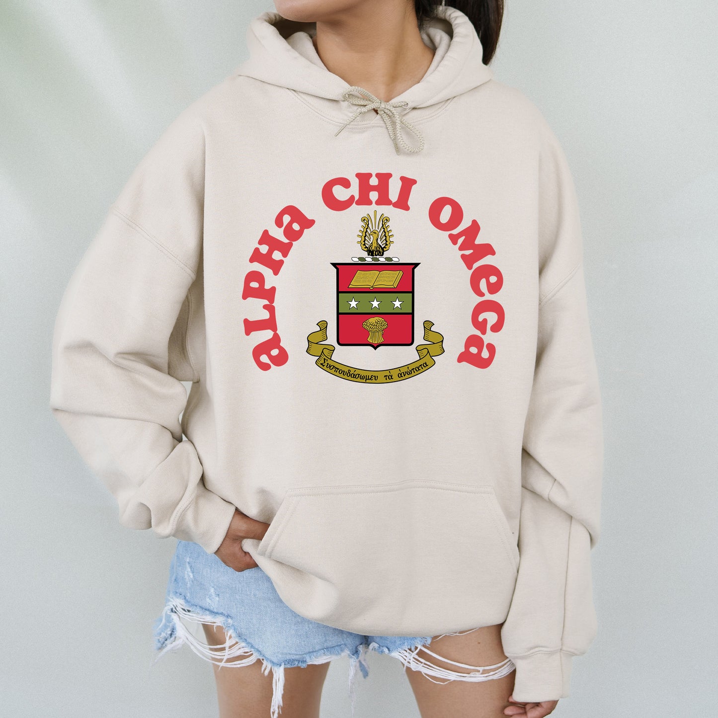 a woman wearing a white hoodie with a crest on it