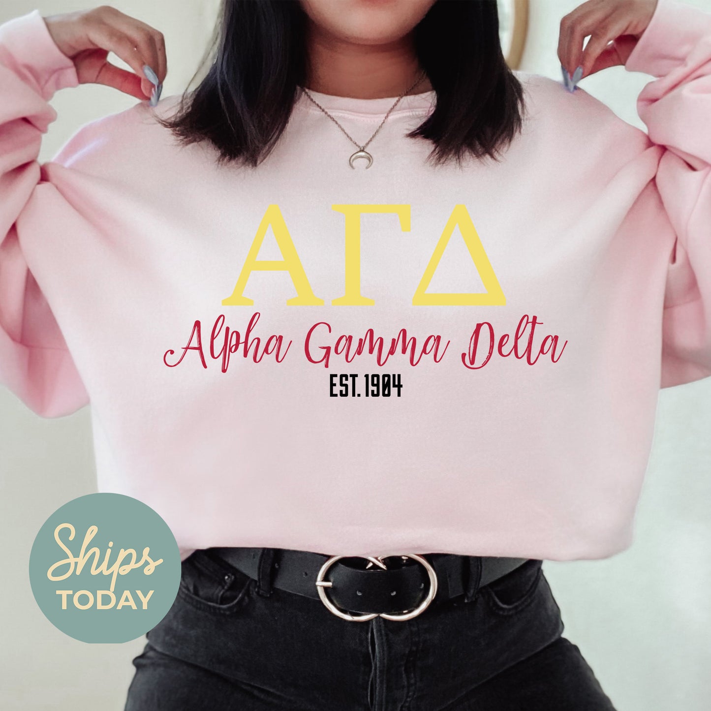 a woman wearing a pink sweatshirt with the letters ata on it