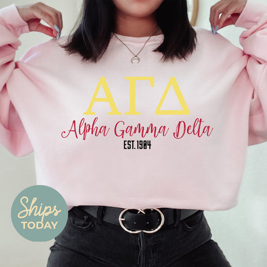 a woman wearing a pink sweatshirt with the letters ata on it