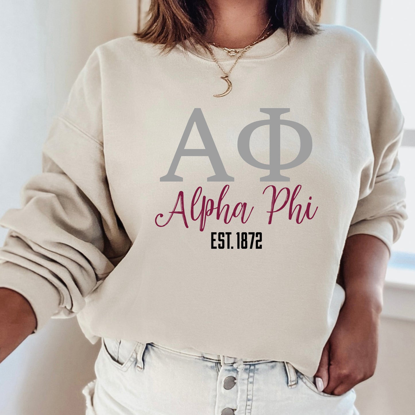 a woman wearing a sweatshirt with the letters ap and phi on it
