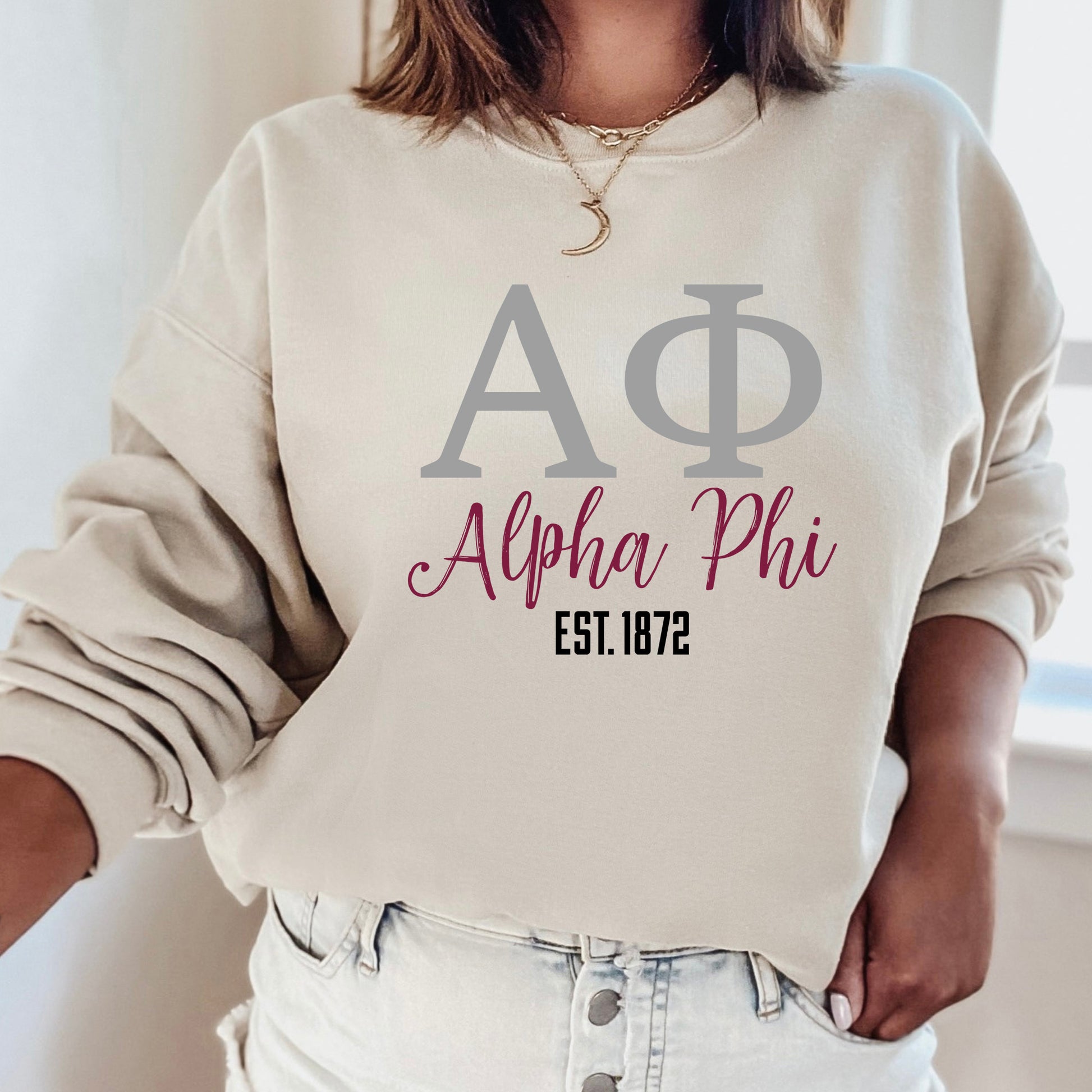 a woman wearing a sweatshirt with the letters ap and phi on it