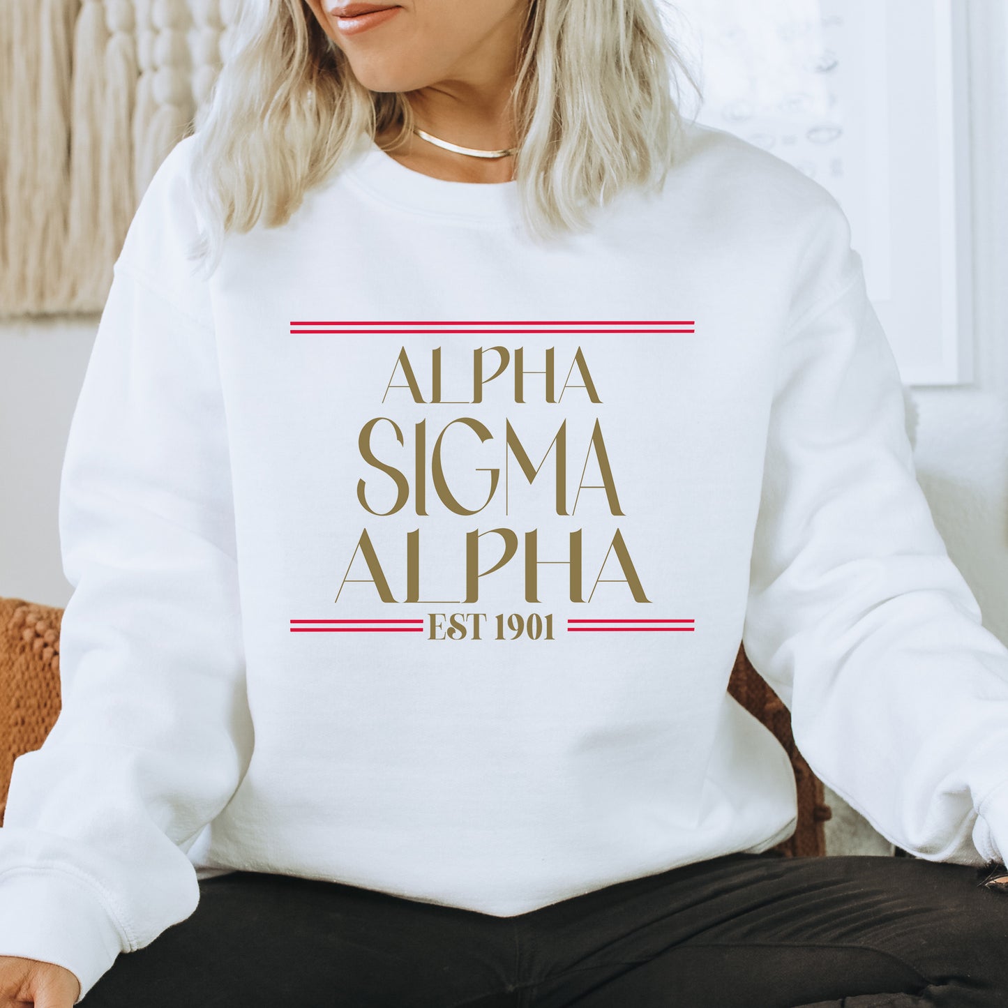 a woman sitting on a chair wearing a white sweatshirt
