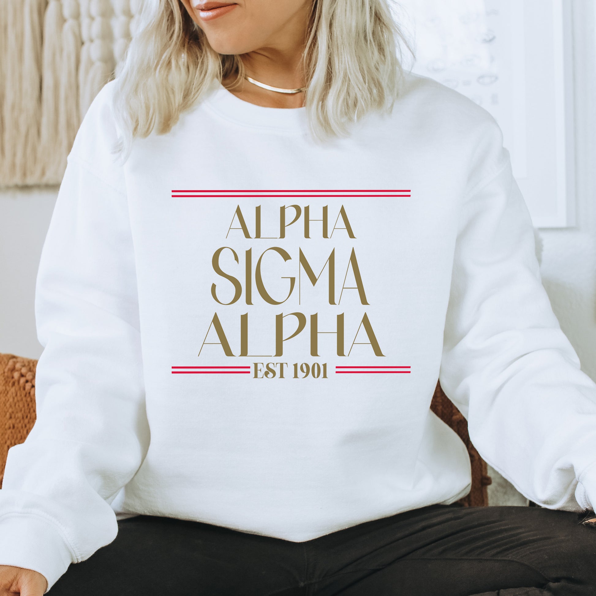 a woman sitting on a chair wearing a white sweatshirt