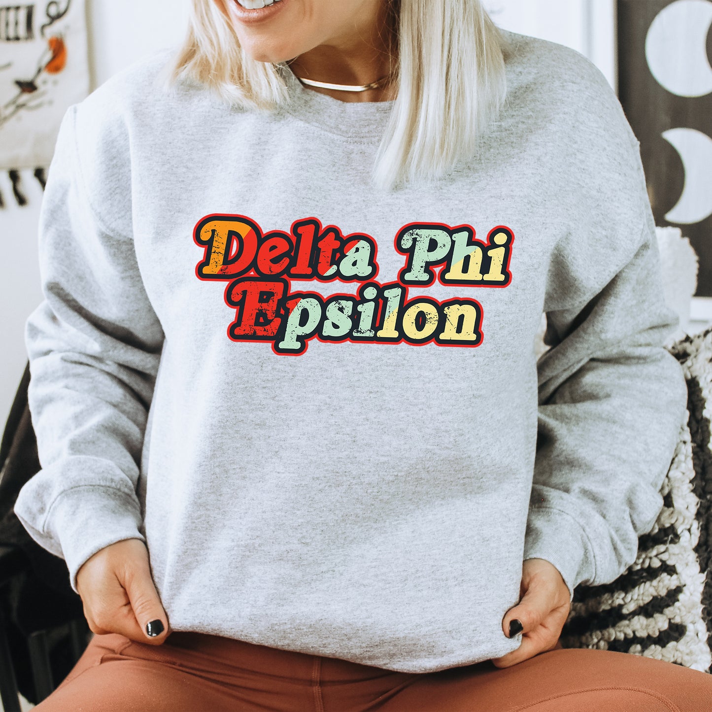 a woman wearing a sweatshirt that says delta phi espion