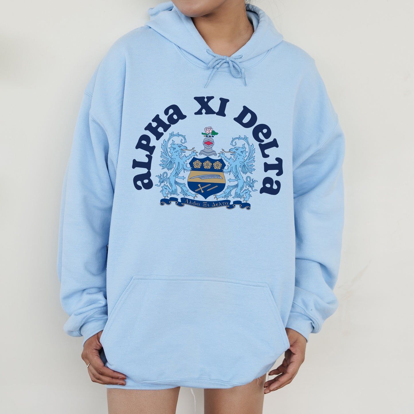 a person wearing a blue hoodie with a crest on it