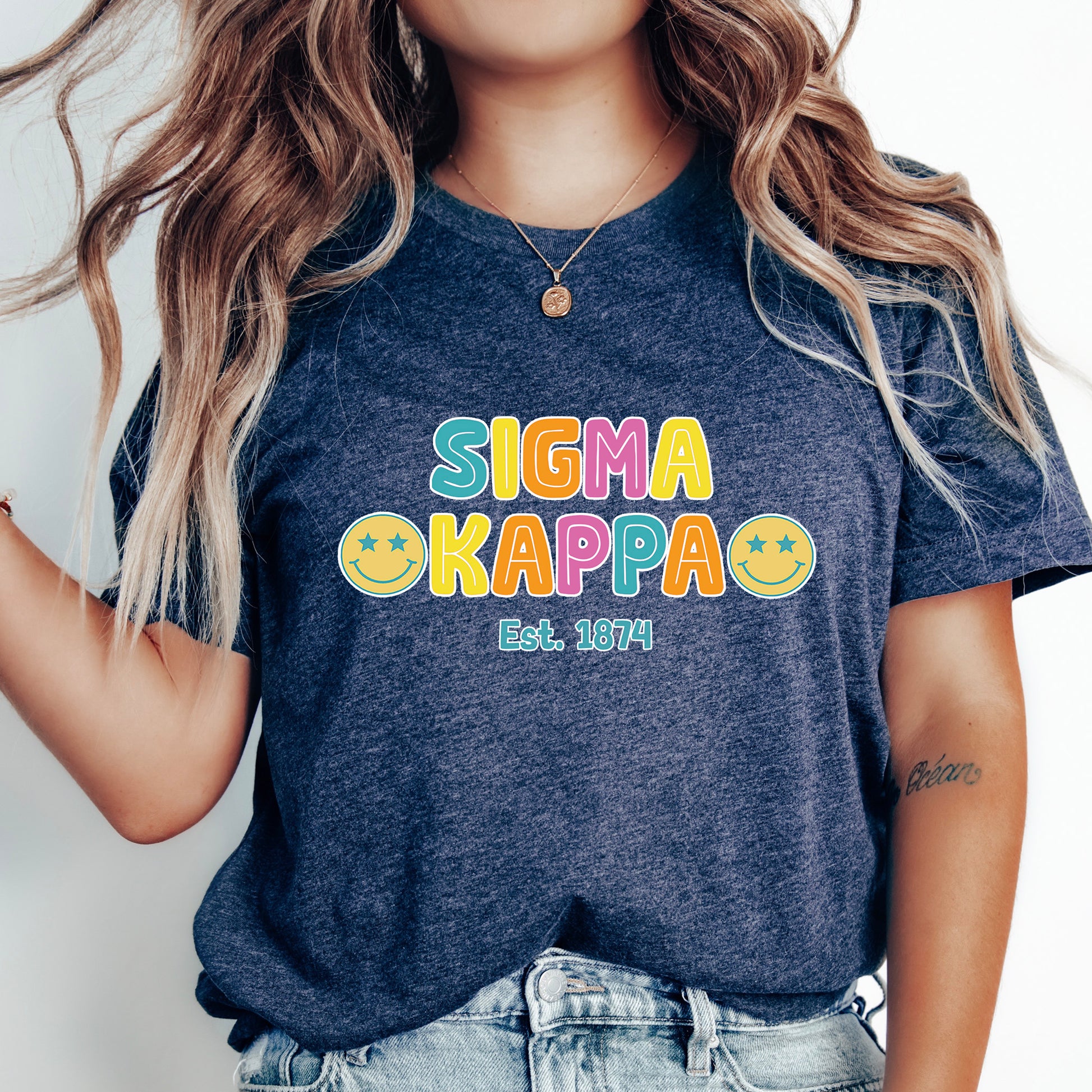 a woman wearing a t - shirt that says stigmaa kappa