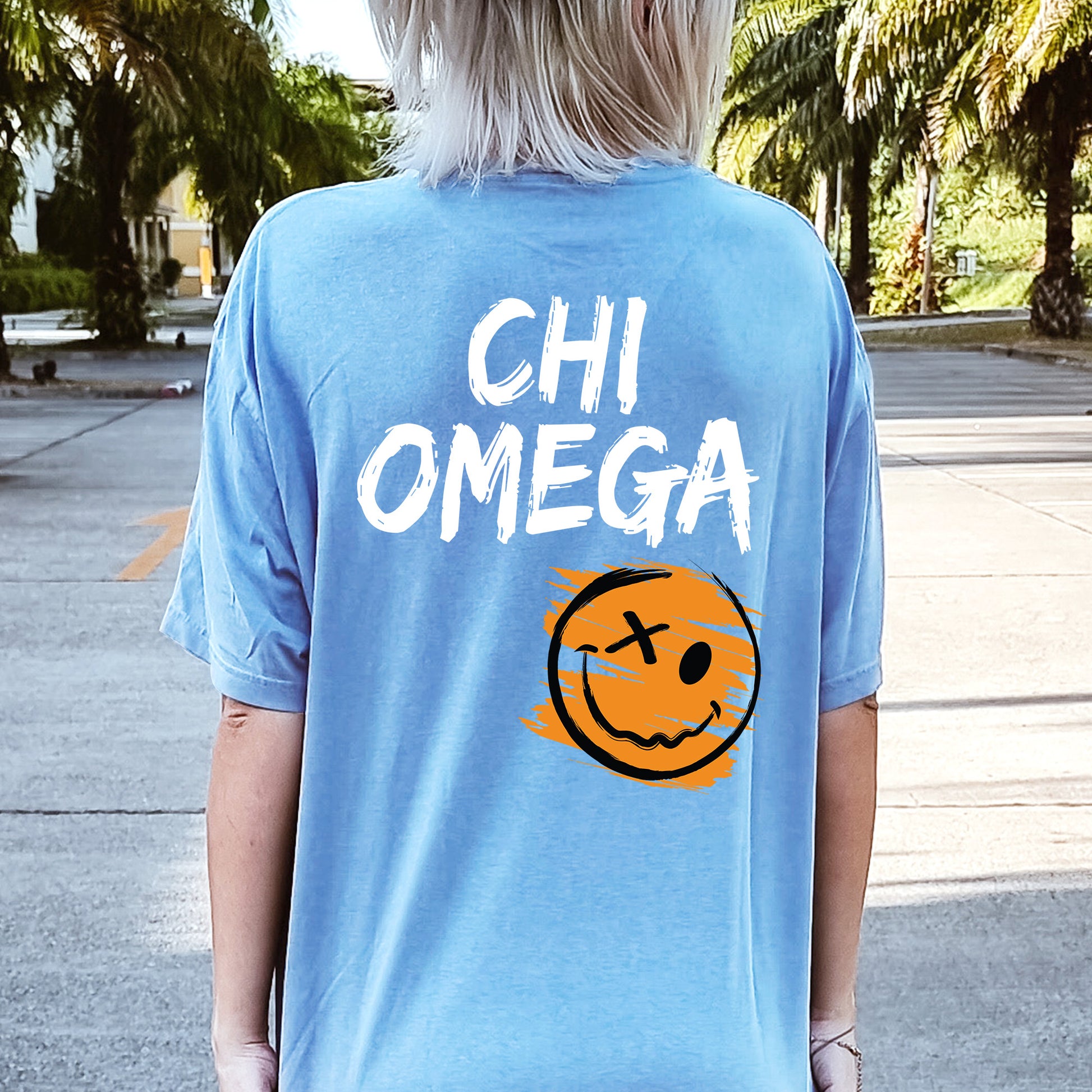 a person wearing a blue shirt with a smiley face on it