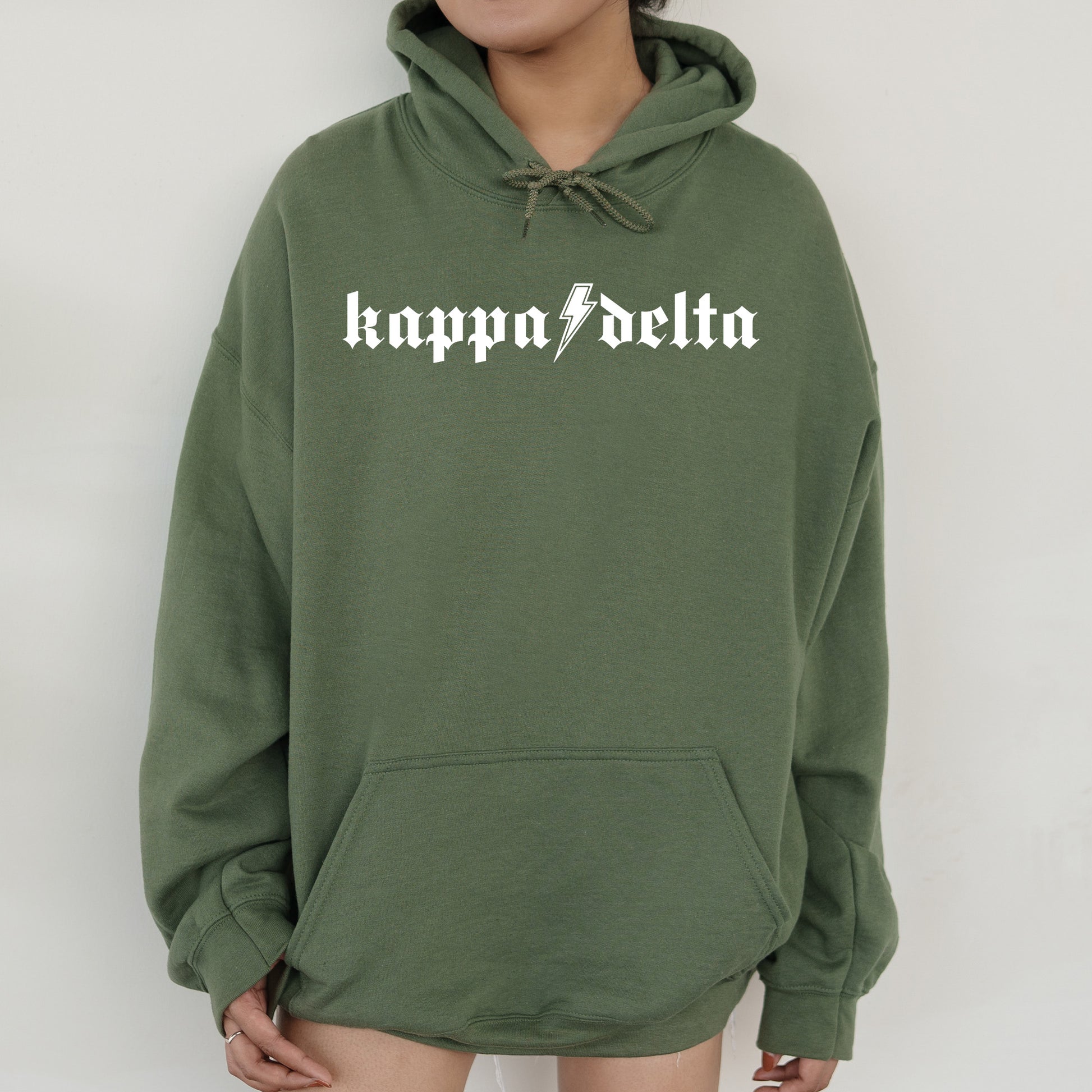 a woman wearing a green hoodie with the word happy delta printed on it