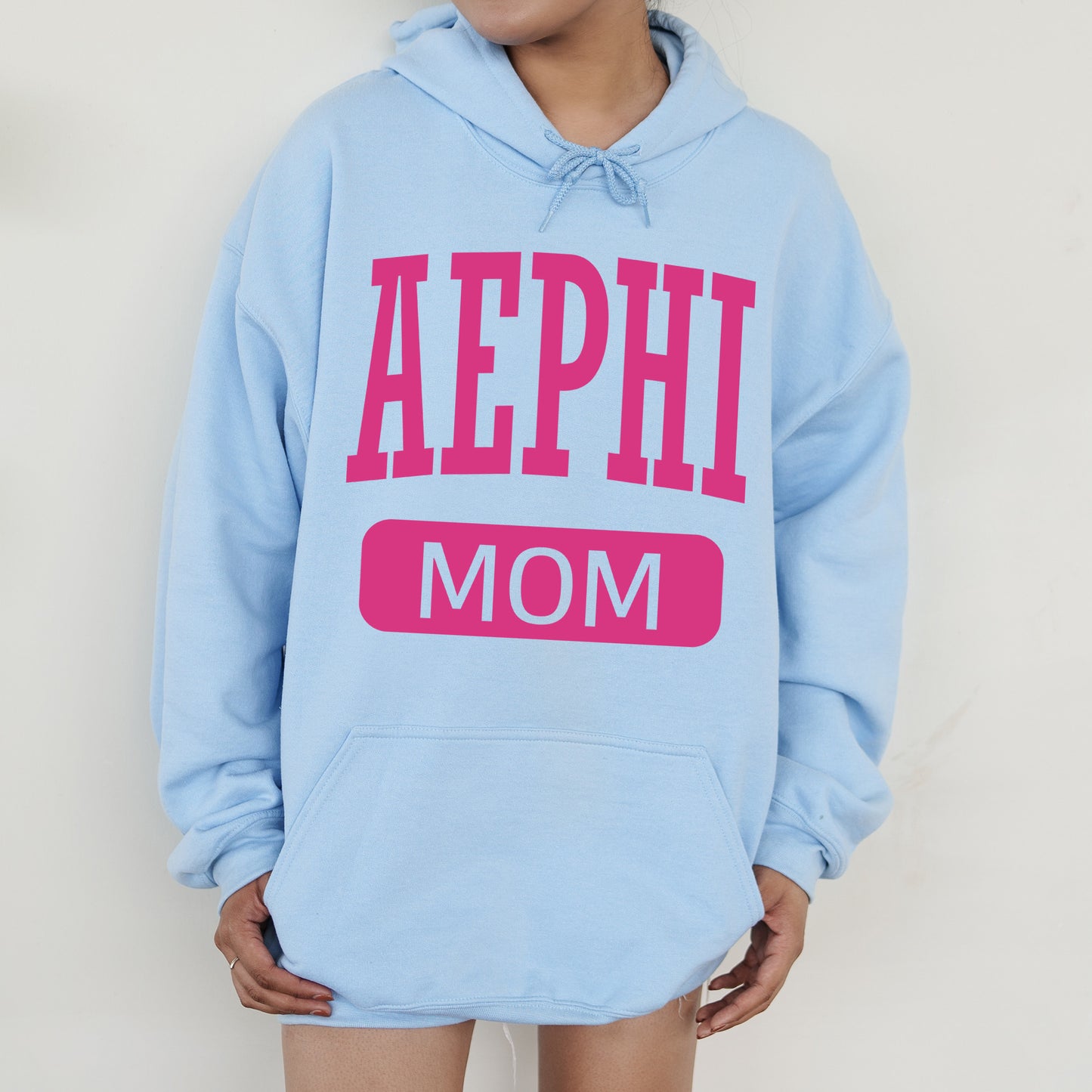 a woman wearing a blue hoodie that says aephh mom