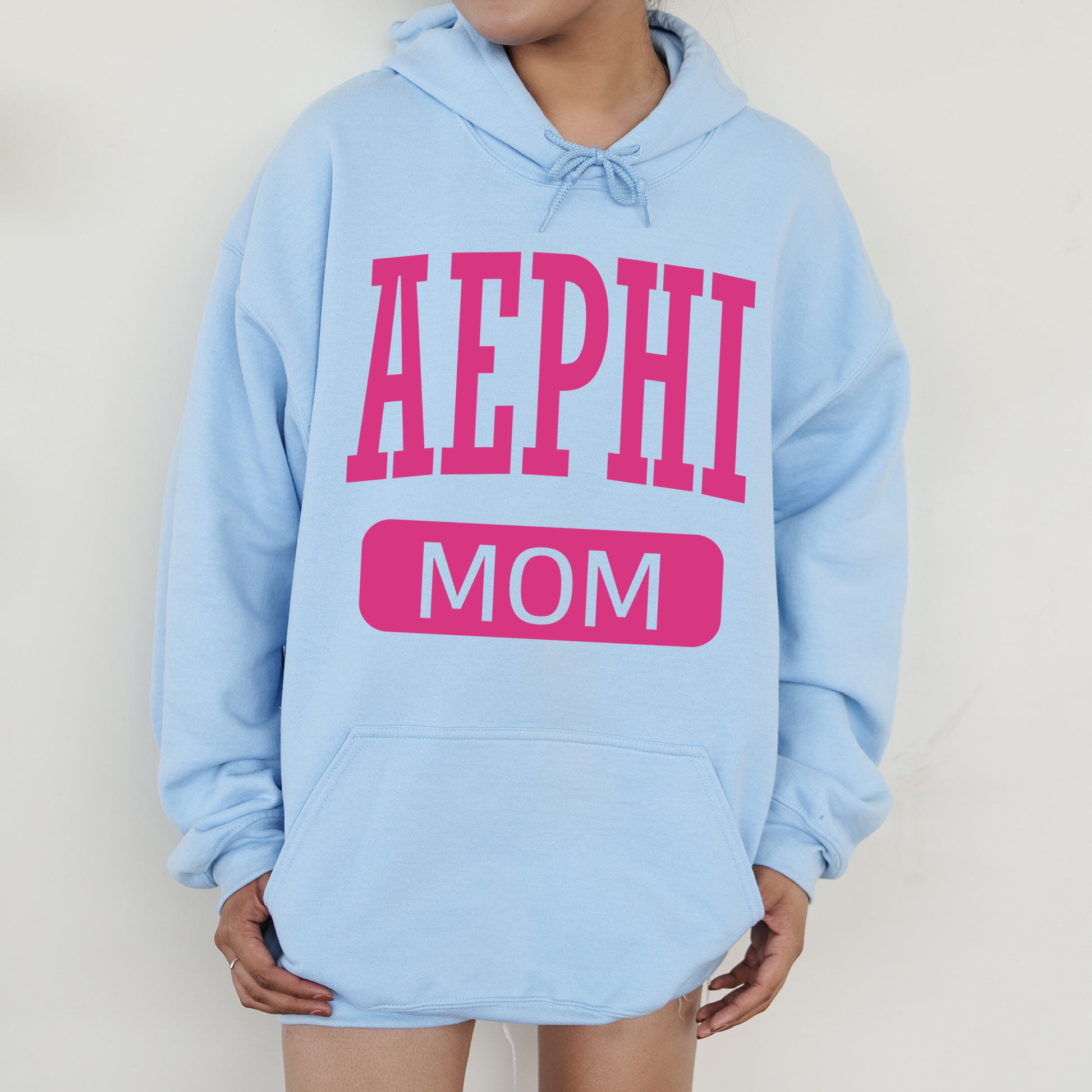 a woman wearing a blue hoodie that says aephh mom