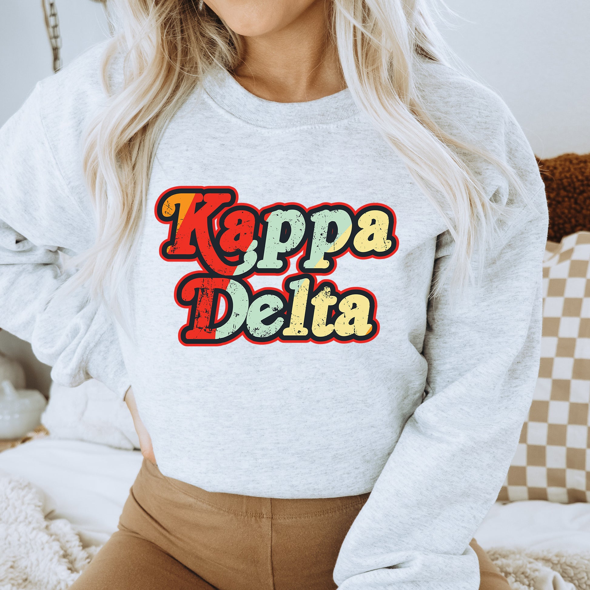 a woman wearing a sweatshirt that says kappa delta
