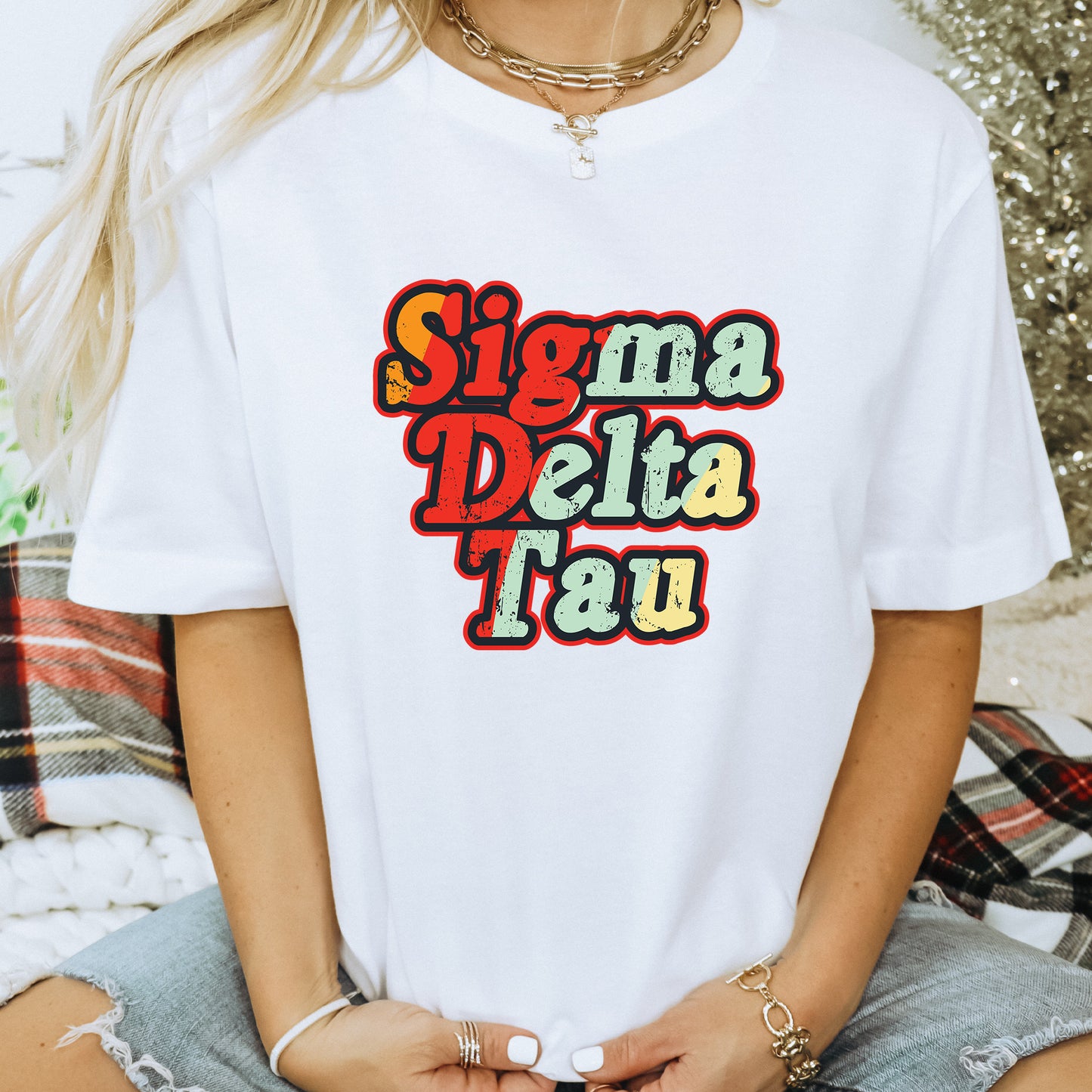 a woman wearing a white t - shirt that says sigm delta tau