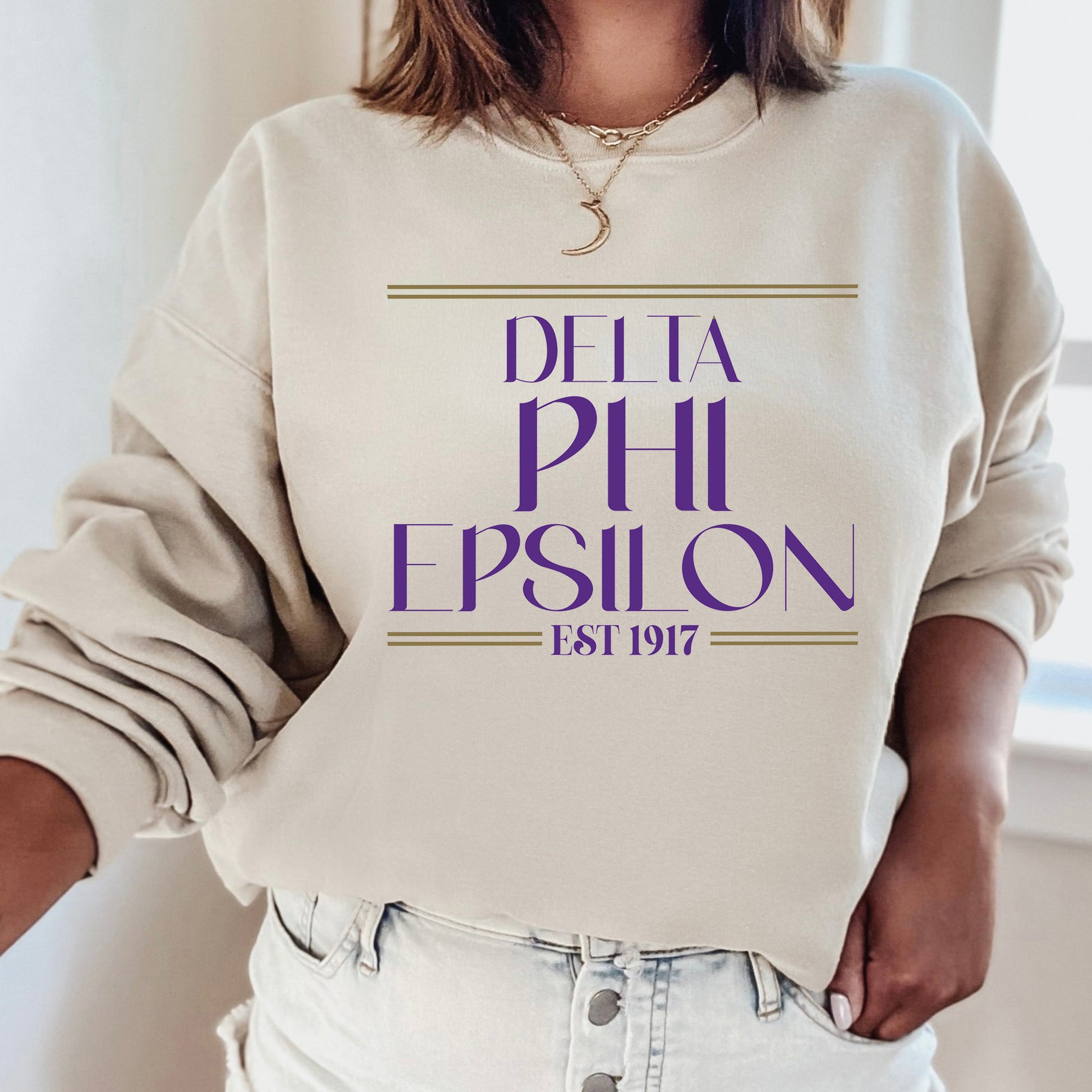 a woman wearing a sweatshirt that says delta phi epsion