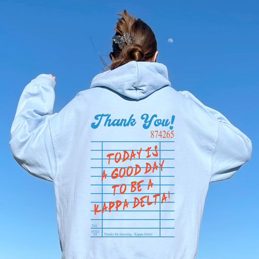 a woman wearing a white hoodie with writing on it