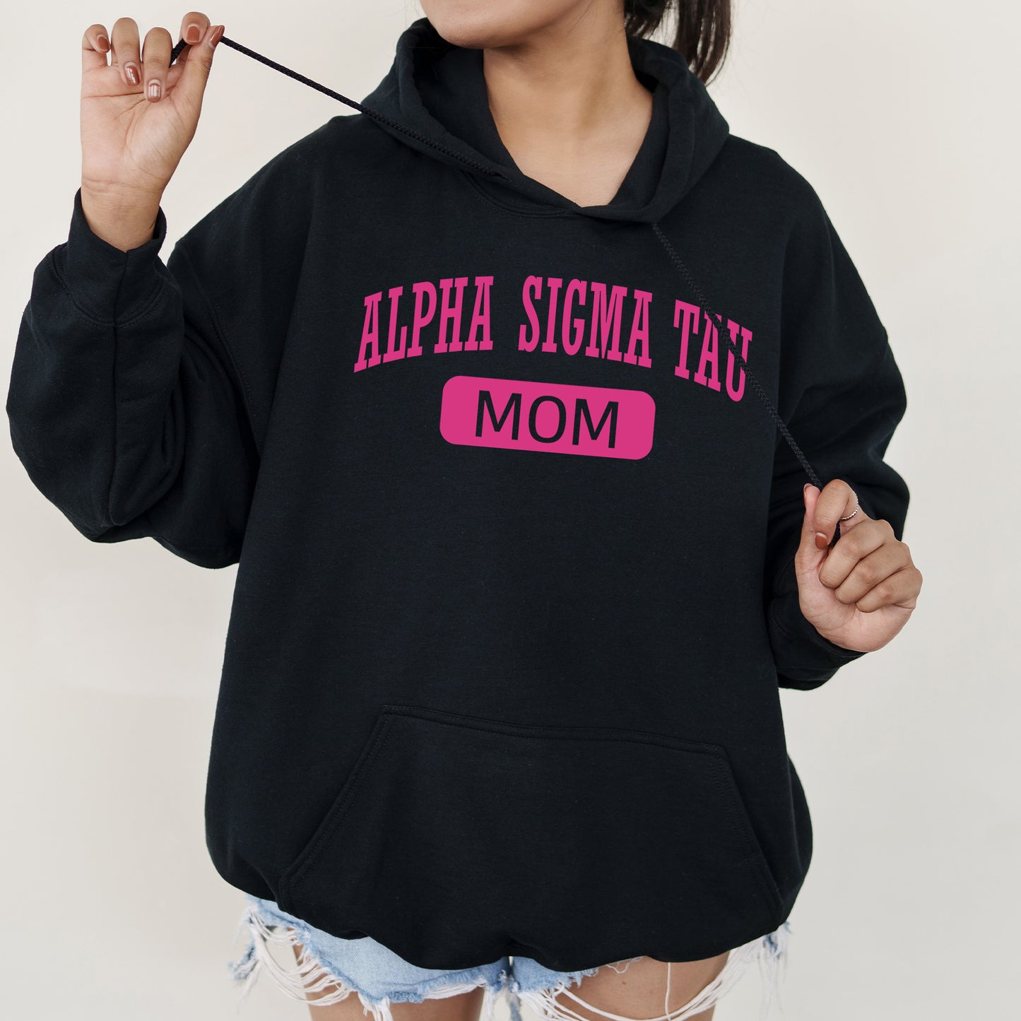 a woman in a black hoodie holding a toothbrush