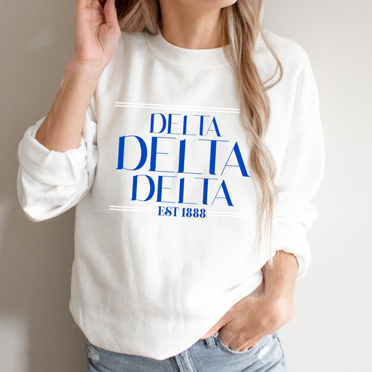 a woman wearing a white sweatshirt with blue letters on it