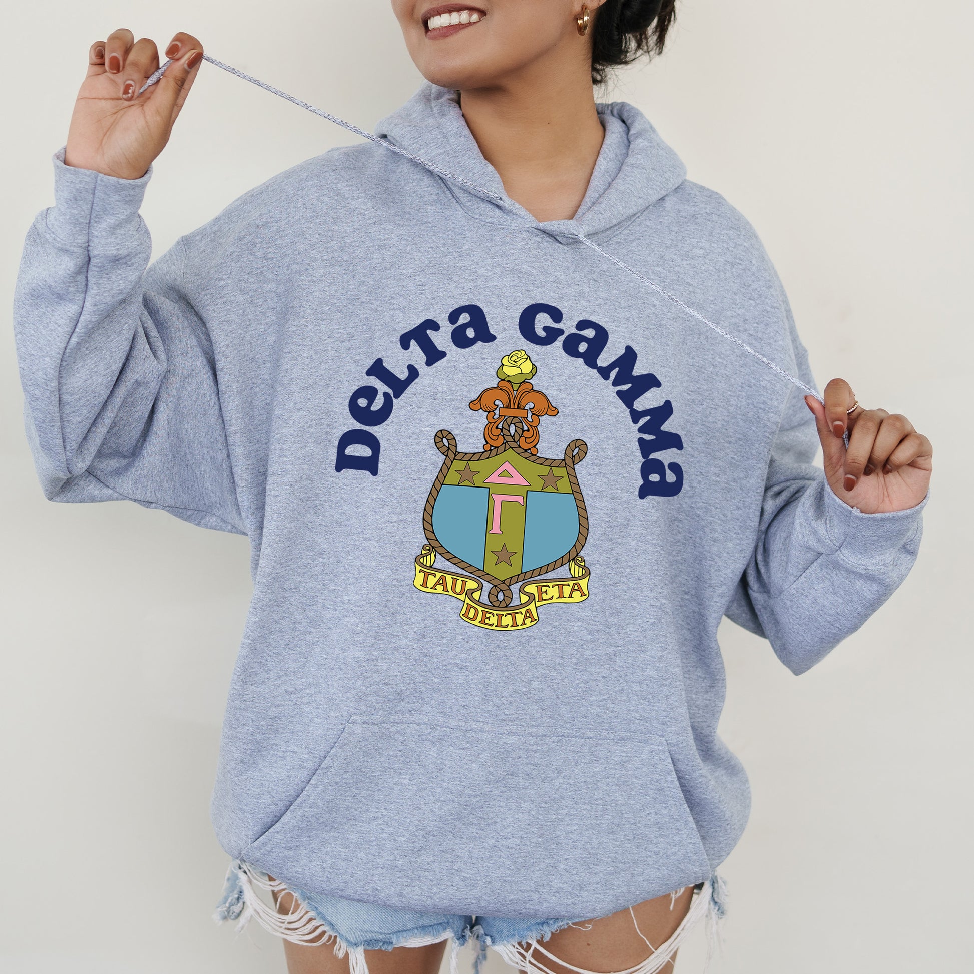a woman in a blue sweatshirt holding a toothbrush