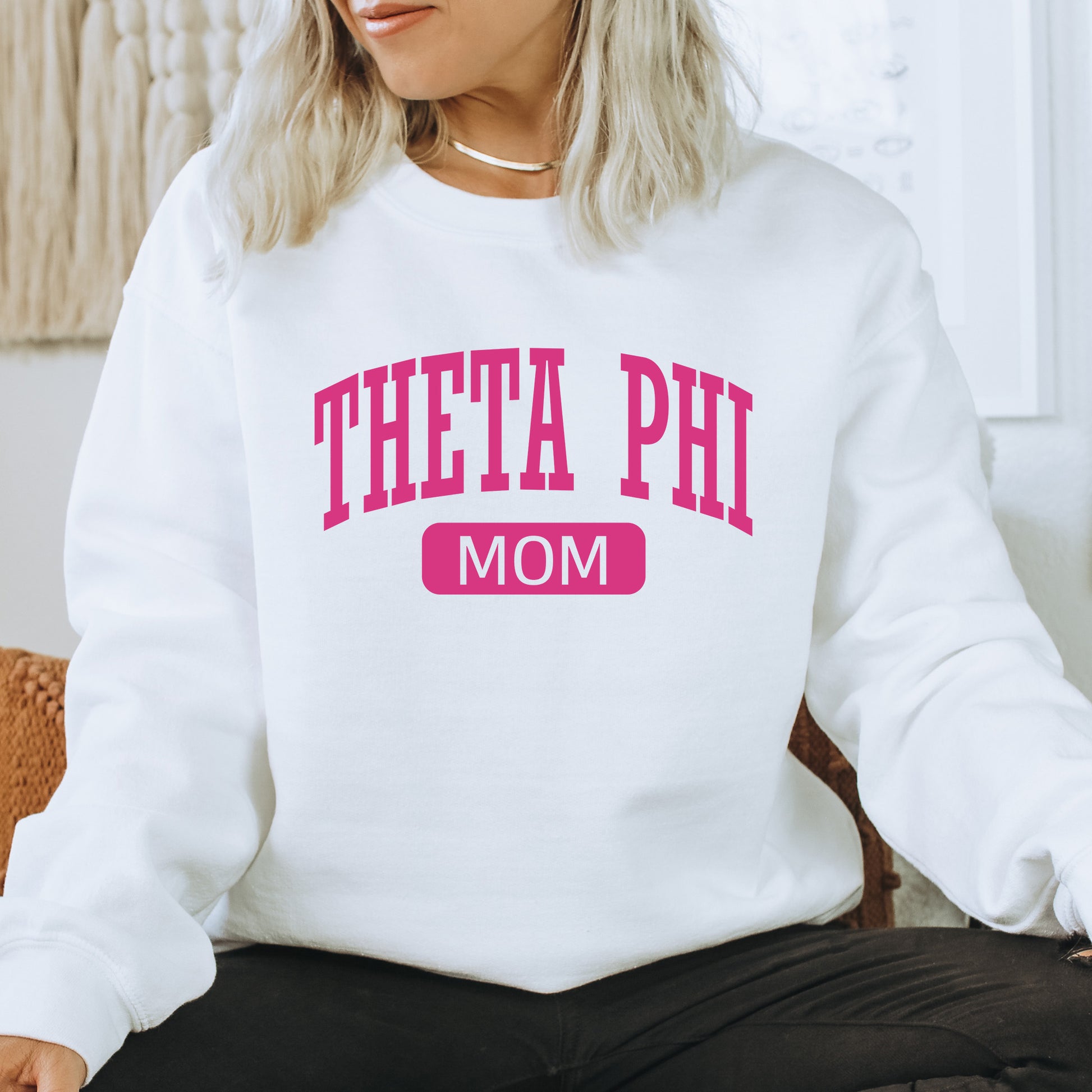 a woman sitting on a chair wearing a sweatshirt that says,'thea ph