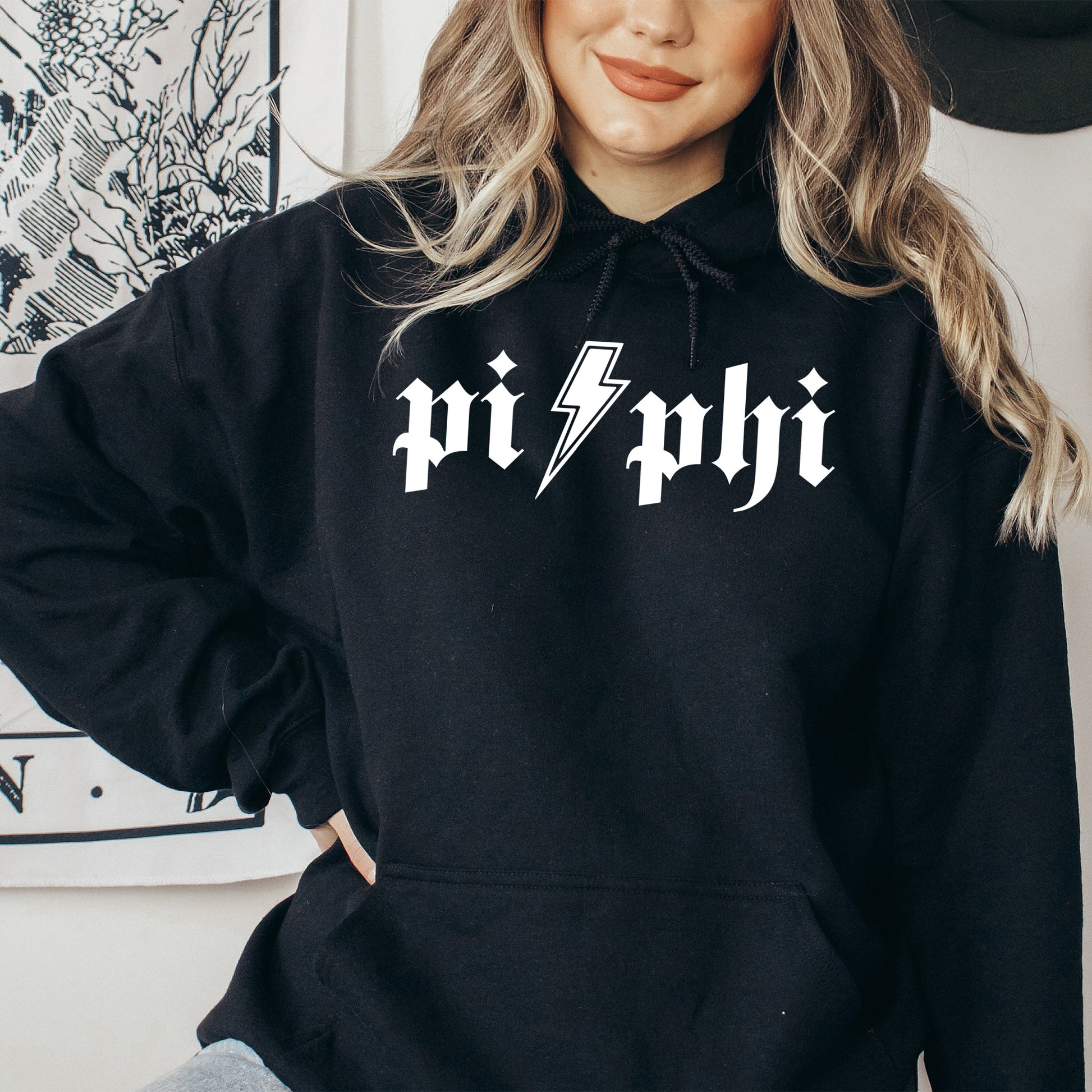 a woman wearing a black hoodie with a lightning bolt on it