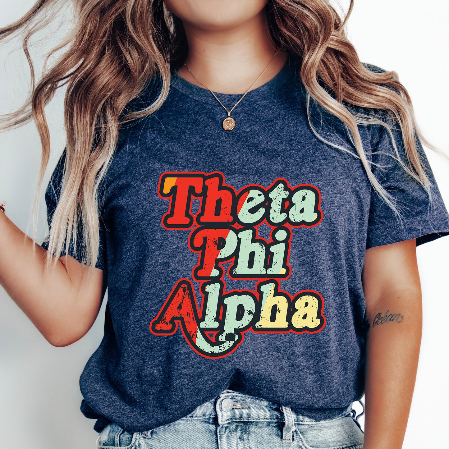 a woman wearing a t - shirt that says thea phi alpha