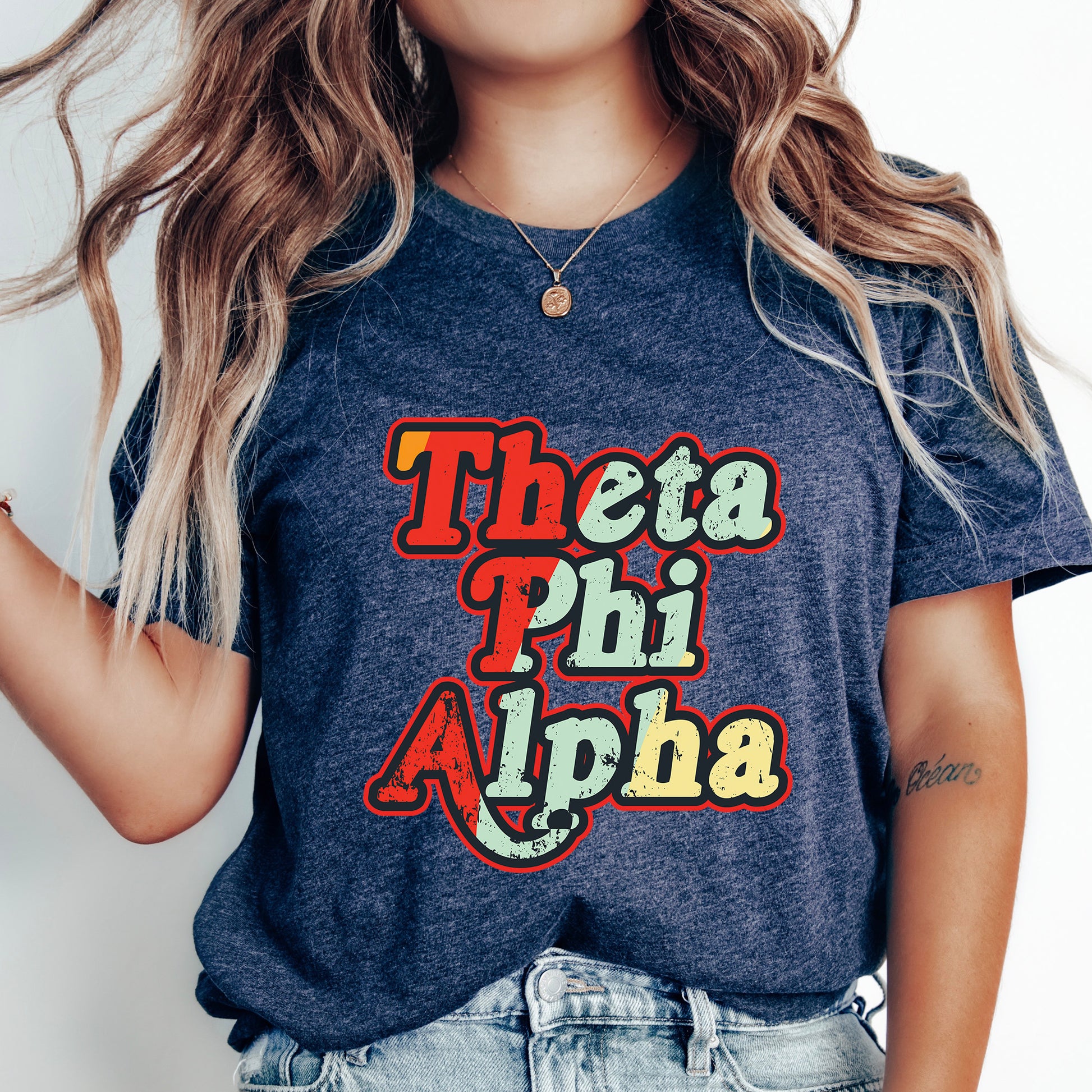 a woman wearing a t - shirt that says thea phi alpha
