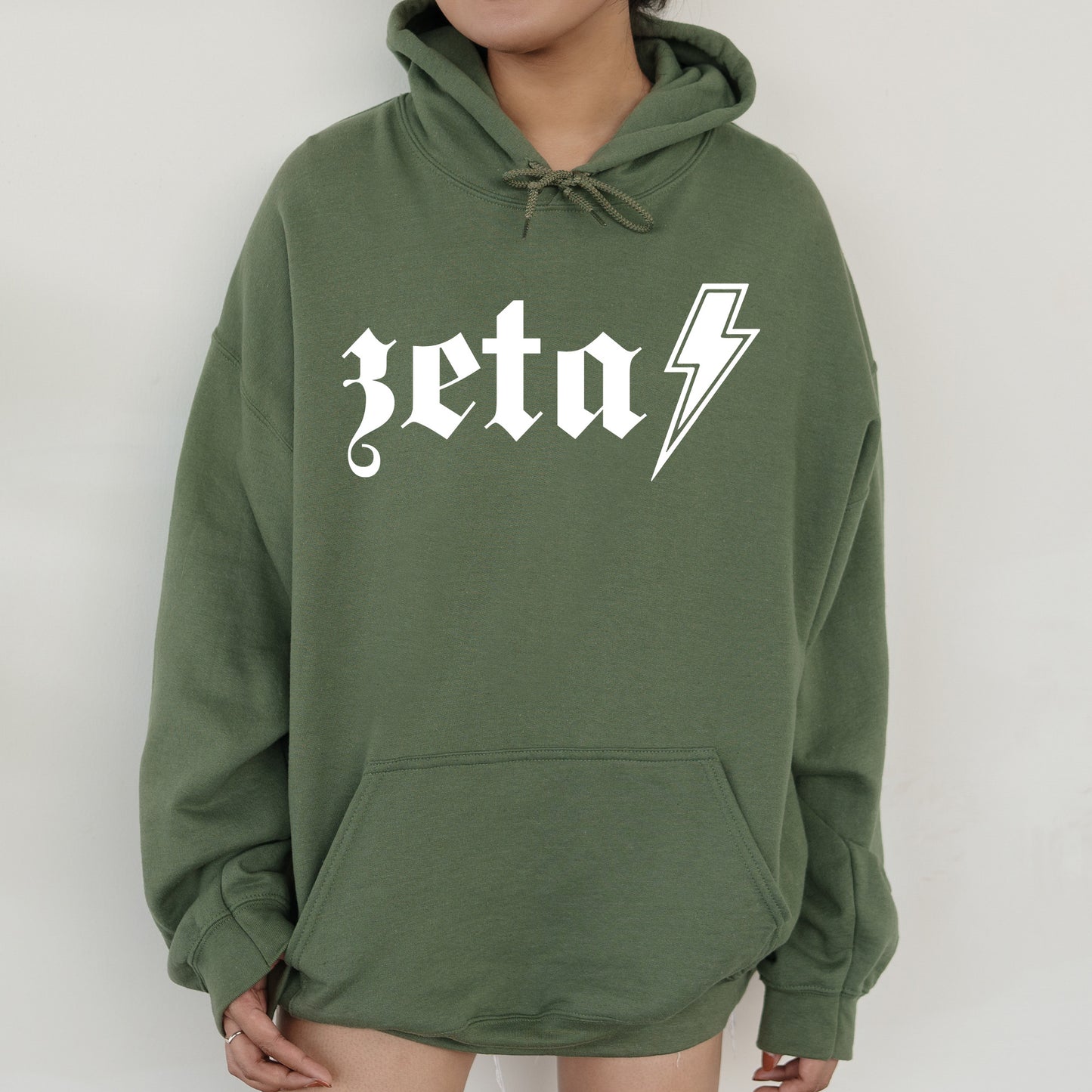 a person wearing a green hoodie with a lightning bolt on it