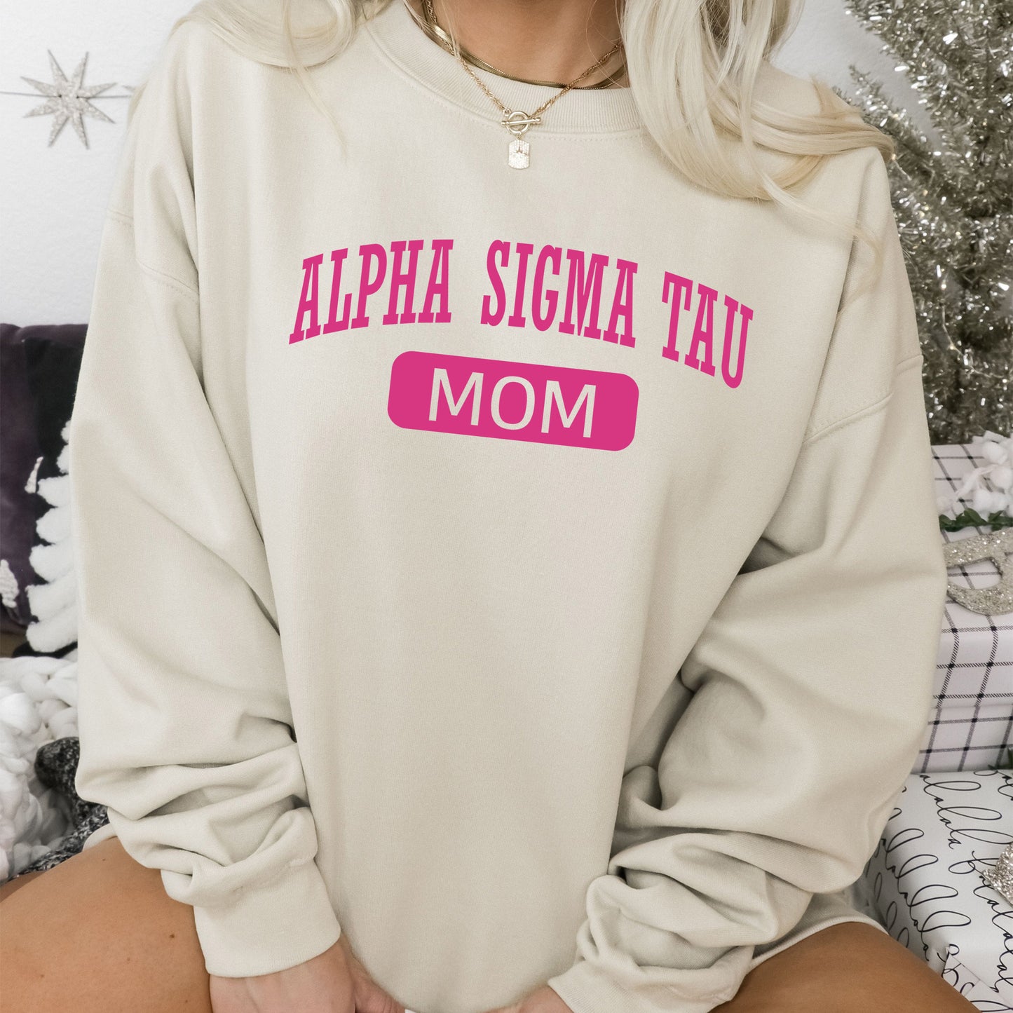 a woman sitting on a couch wearing a sweatshirt