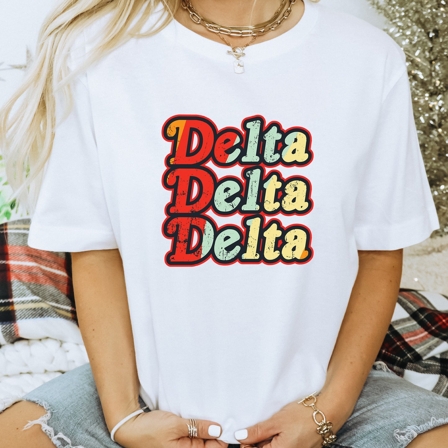 a woman wearing a white t - shirt that says delta delta
