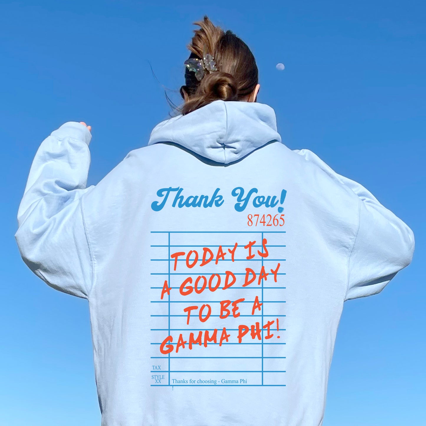 a woman wearing a white hoodie with writing on it