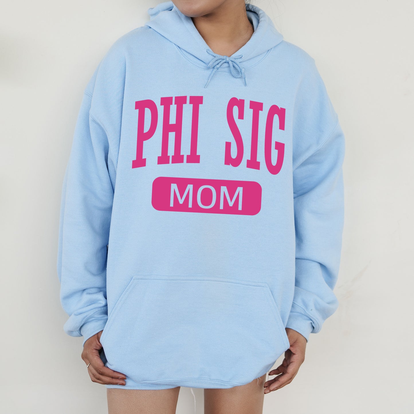 a woman wearing a blue phi sig mom hoodie