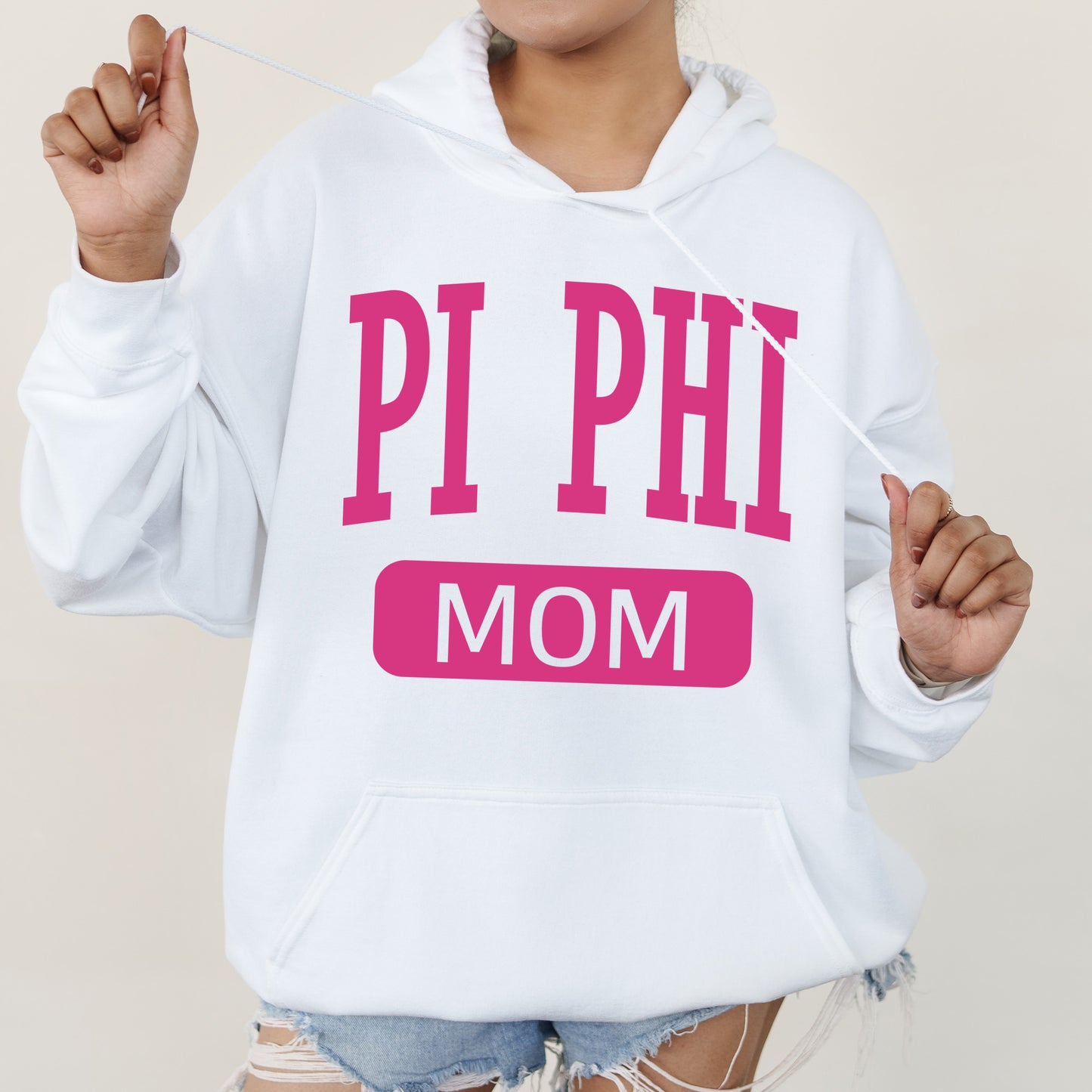 a woman wearing a hoodie that says pi phi mom