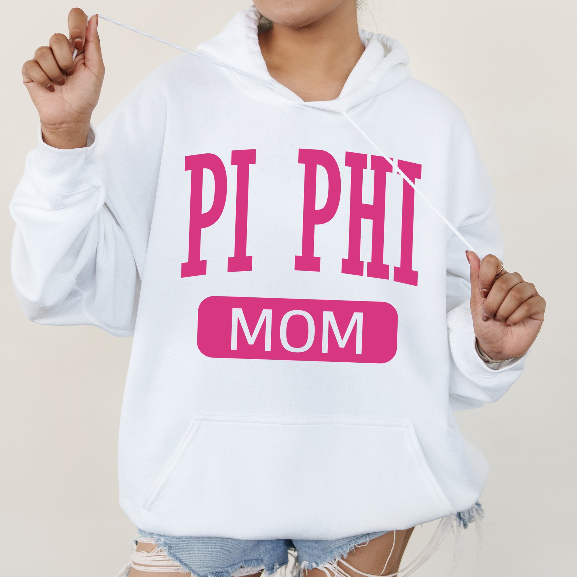 a woman wearing a hoodie that says pi phi mom