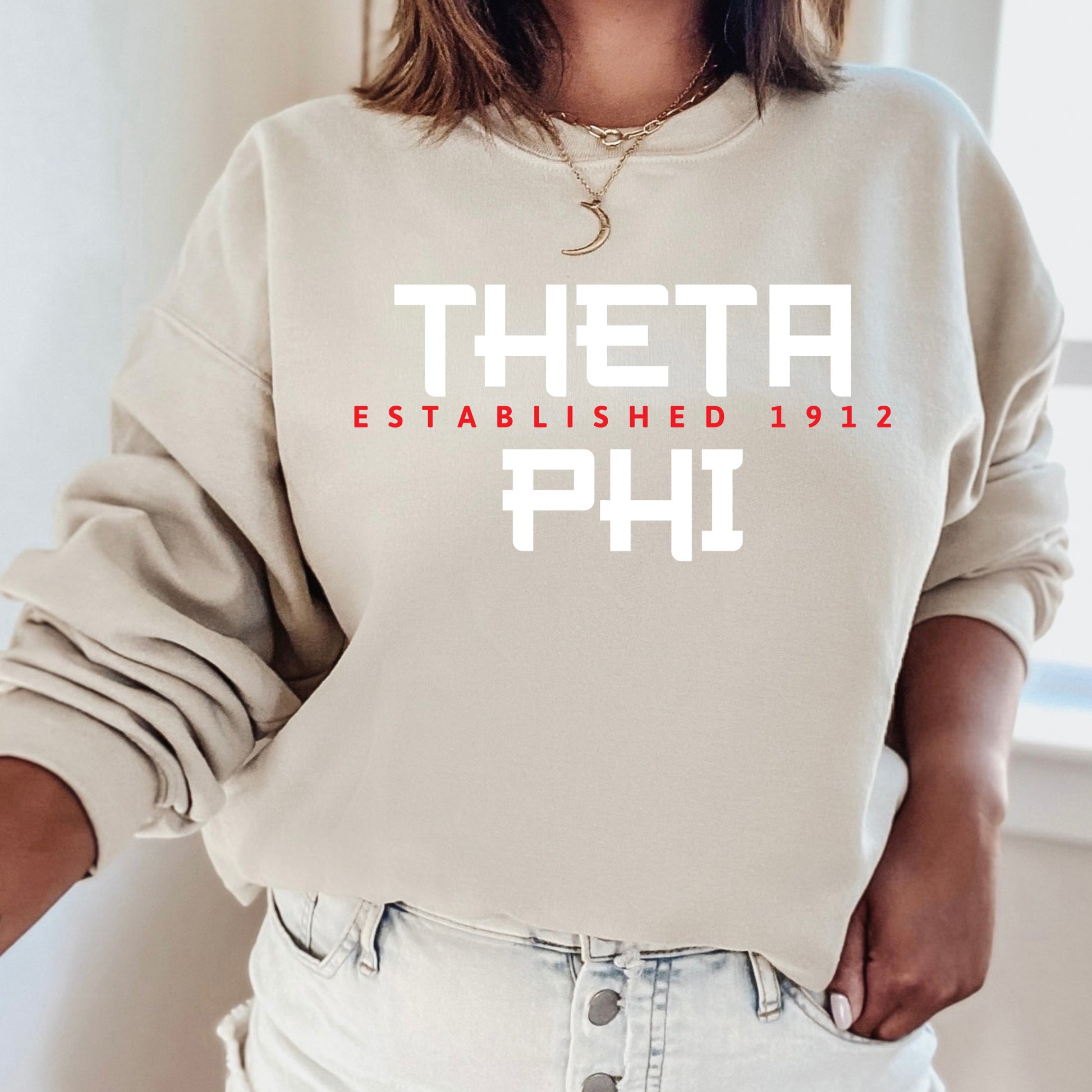 a woman wearing a sweatshirt that says thea established 1911