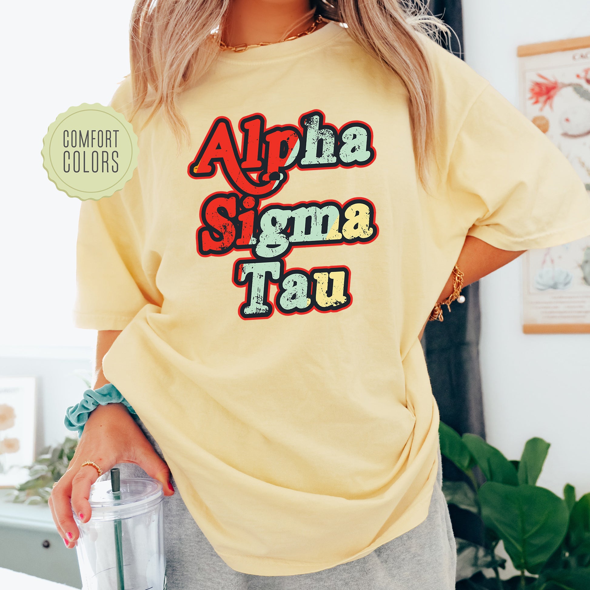 a woman wearing a yellow shirt with the words aloha stigma tau on it