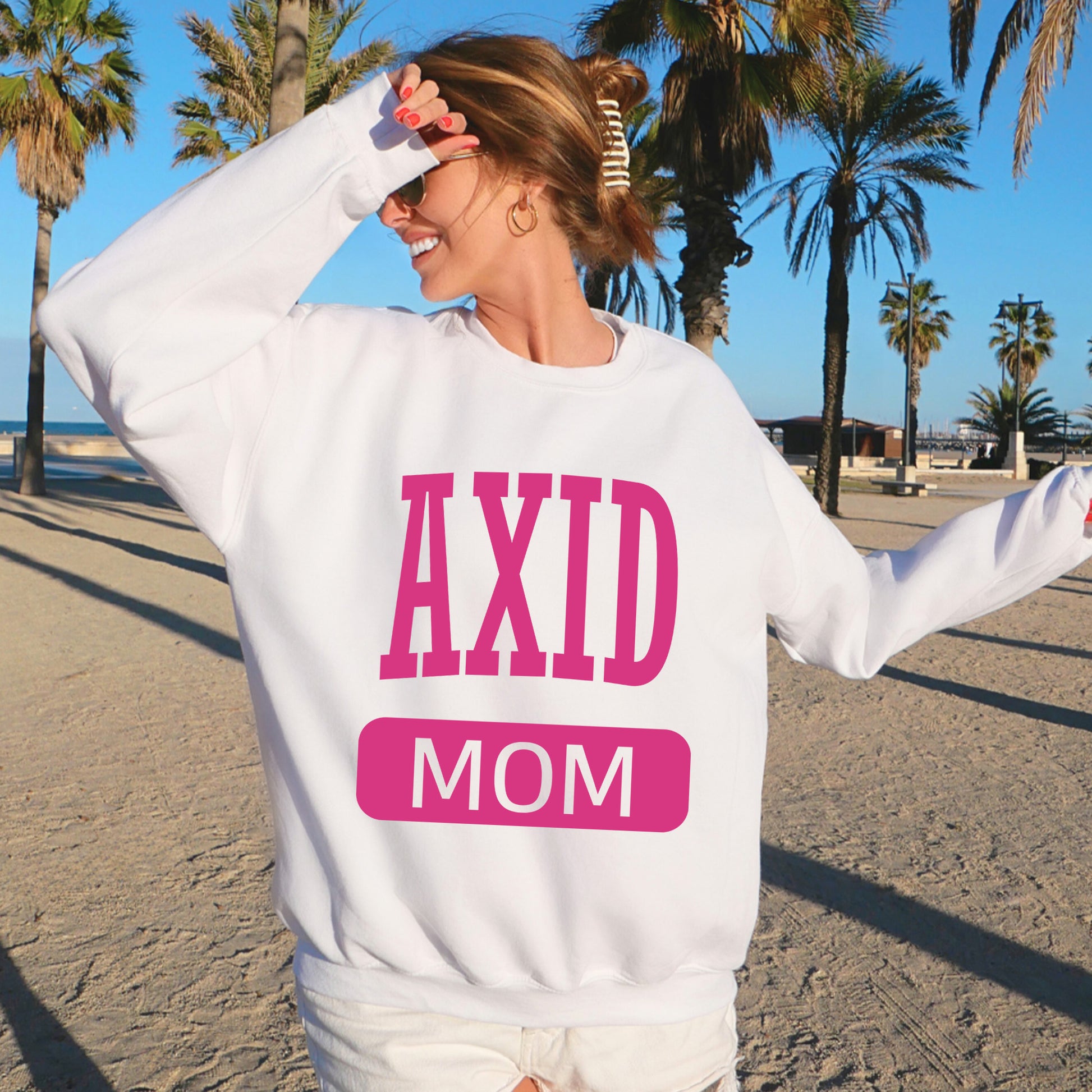 a woman wearing a sweatshirt that says axd mom