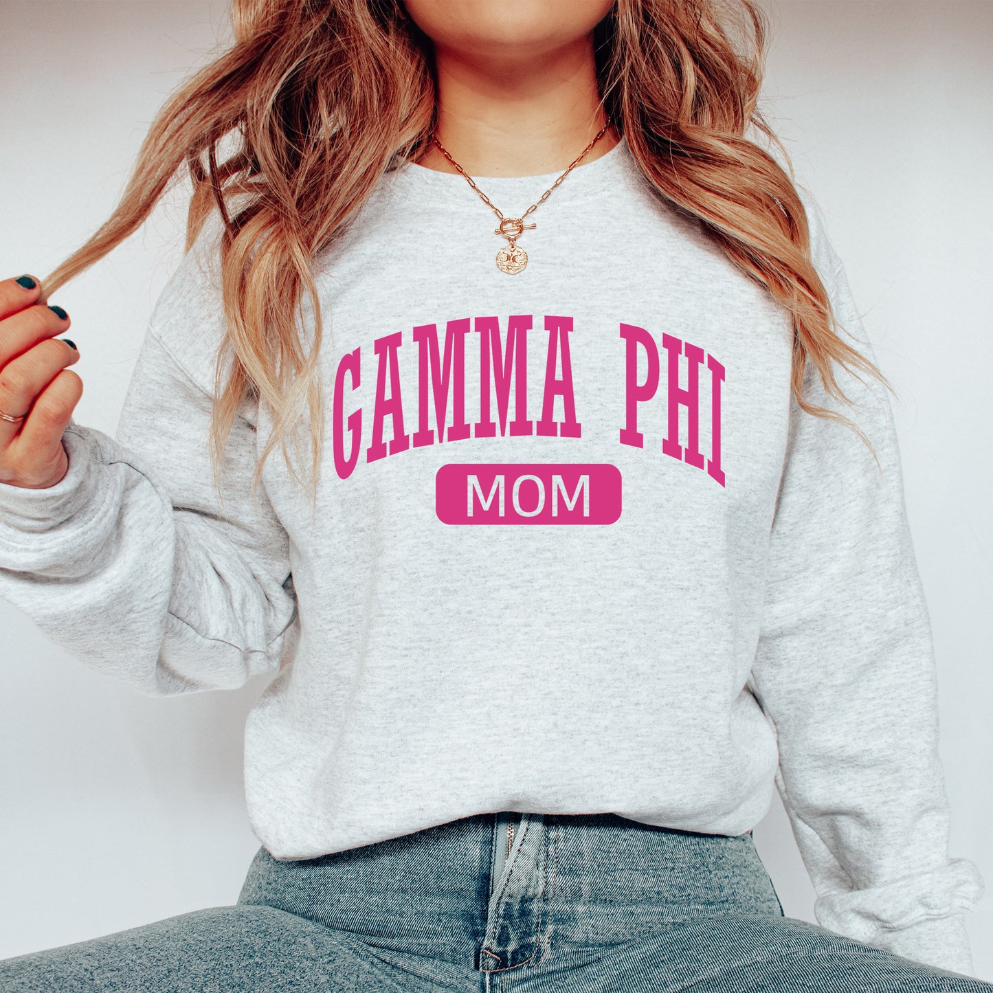 a woman wearing a sweatshirt with the word gama phi on it