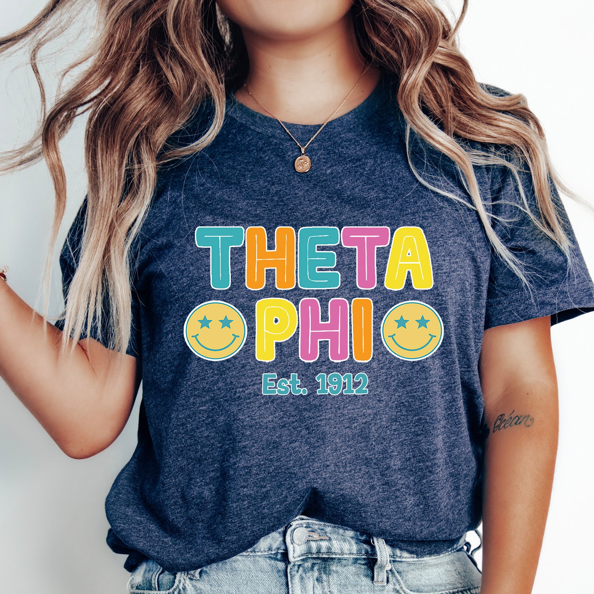 a woman wearing a t - shirt that says thea phi est 2012