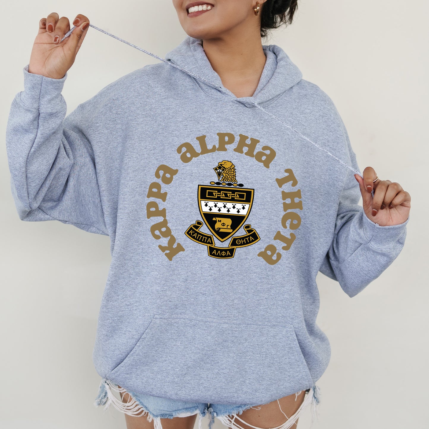 a woman in a blue hoodie holding a toothbrush