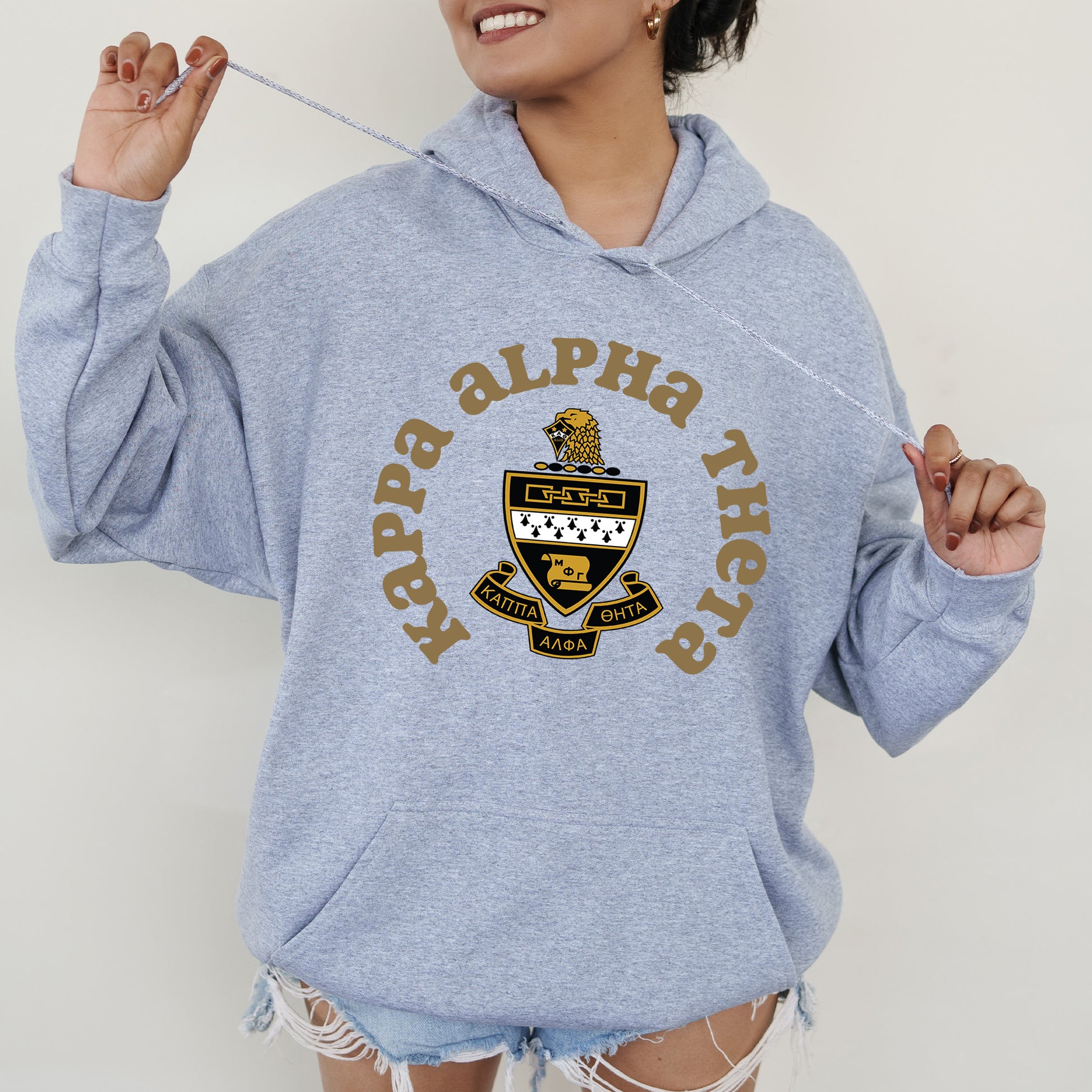 a woman in a blue hoodie holding a toothbrush