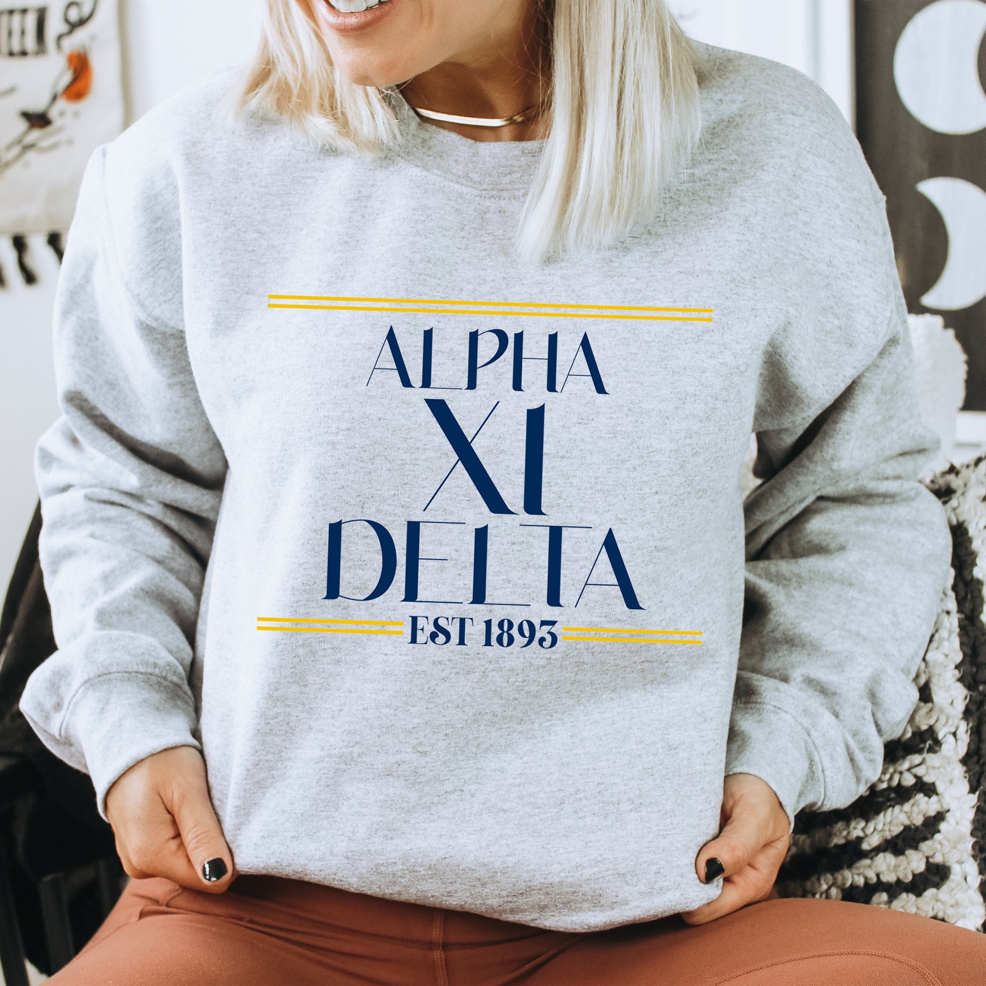 a woman sitting on a chair wearing a sweatshirt