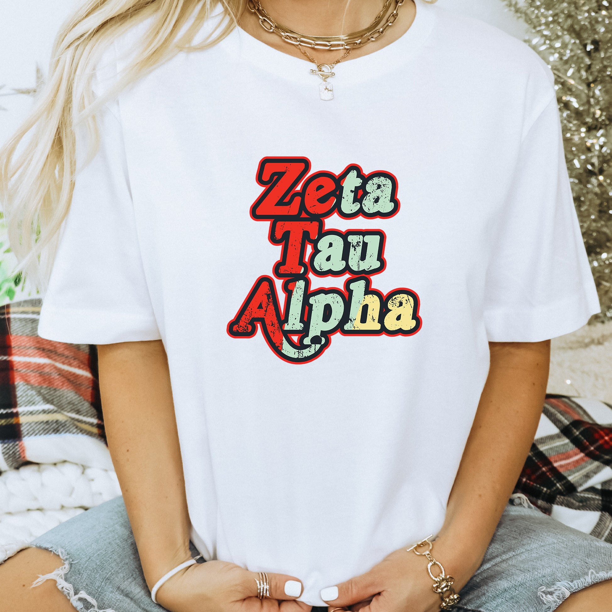 a woman wearing a white t - shirt with the word zeta taqui al