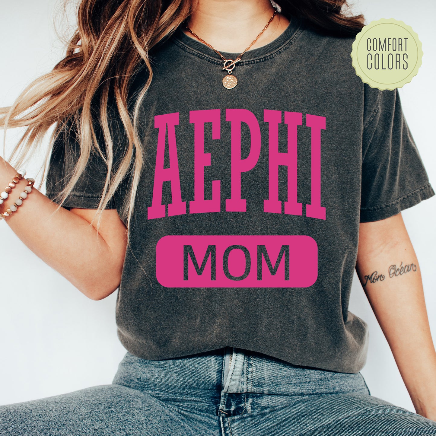 a woman wearing a shirt that says aephi mom